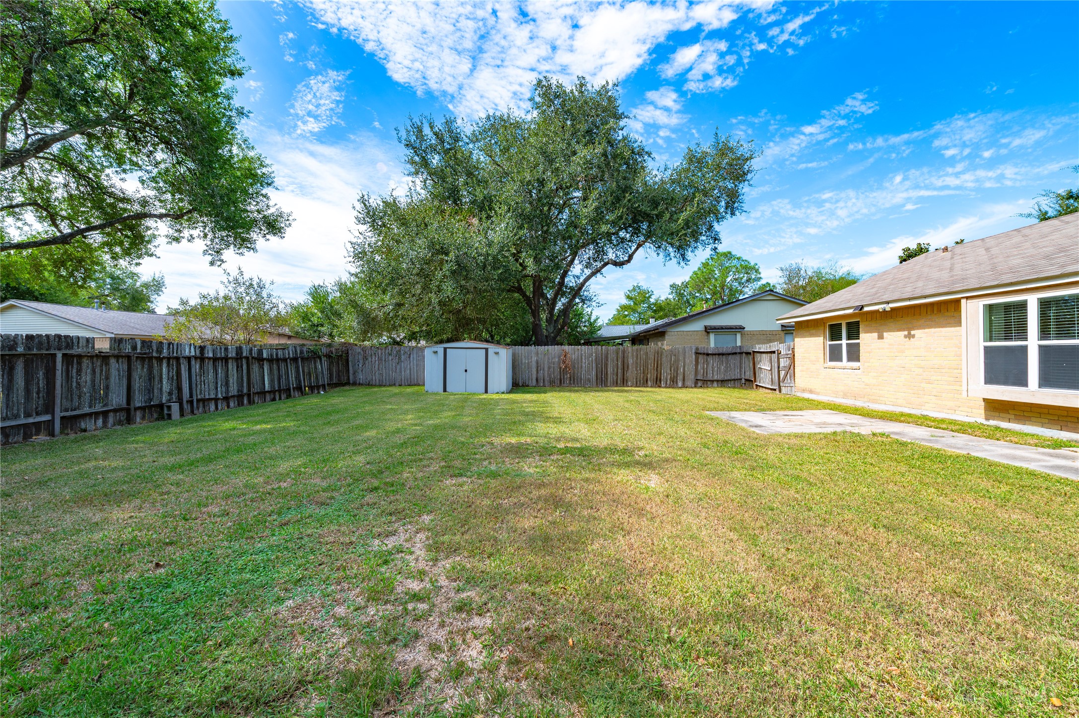 Large backyard with privacy fencing on all sides.