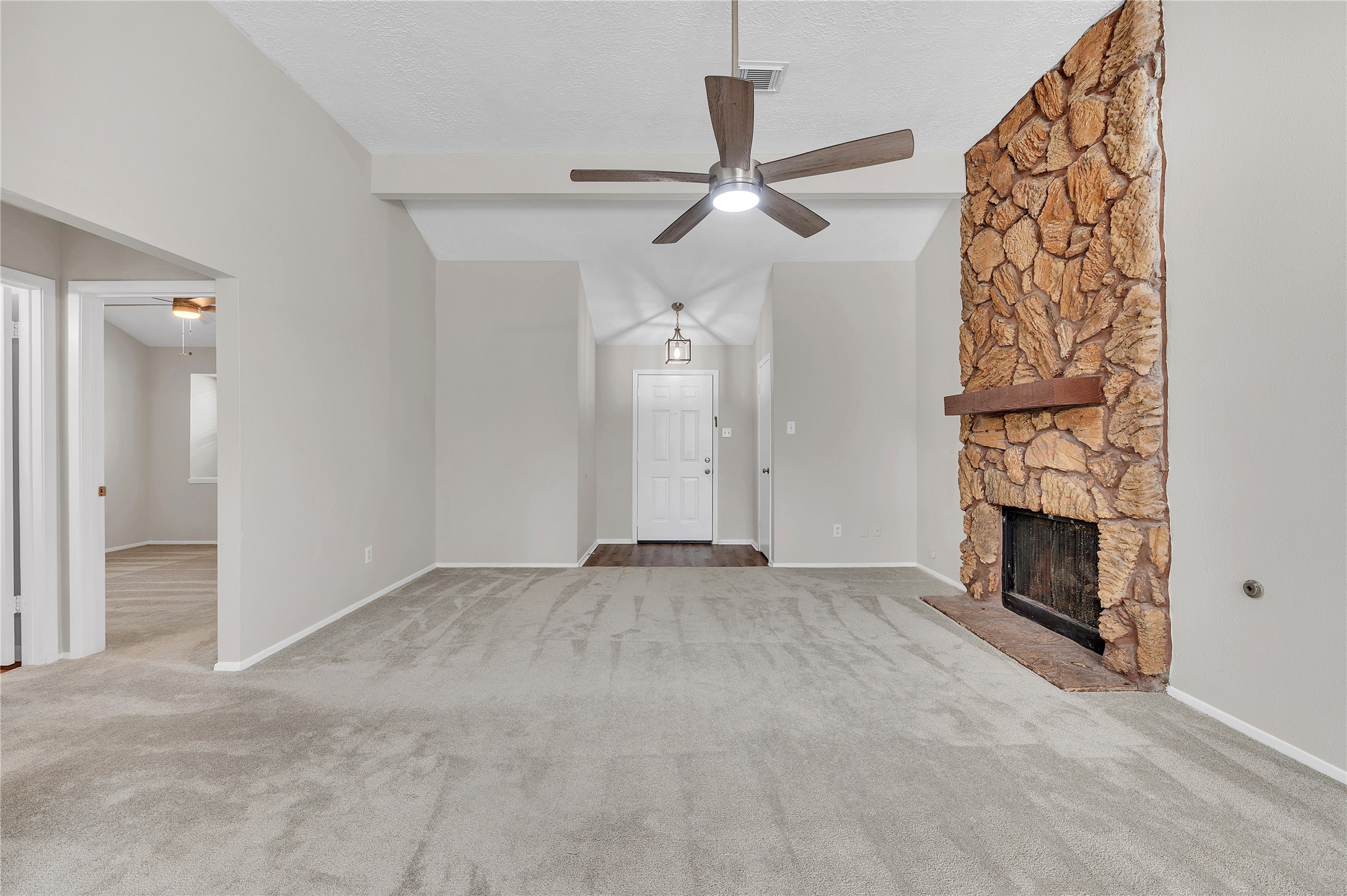 Another view of the large living room space with high ceilings.