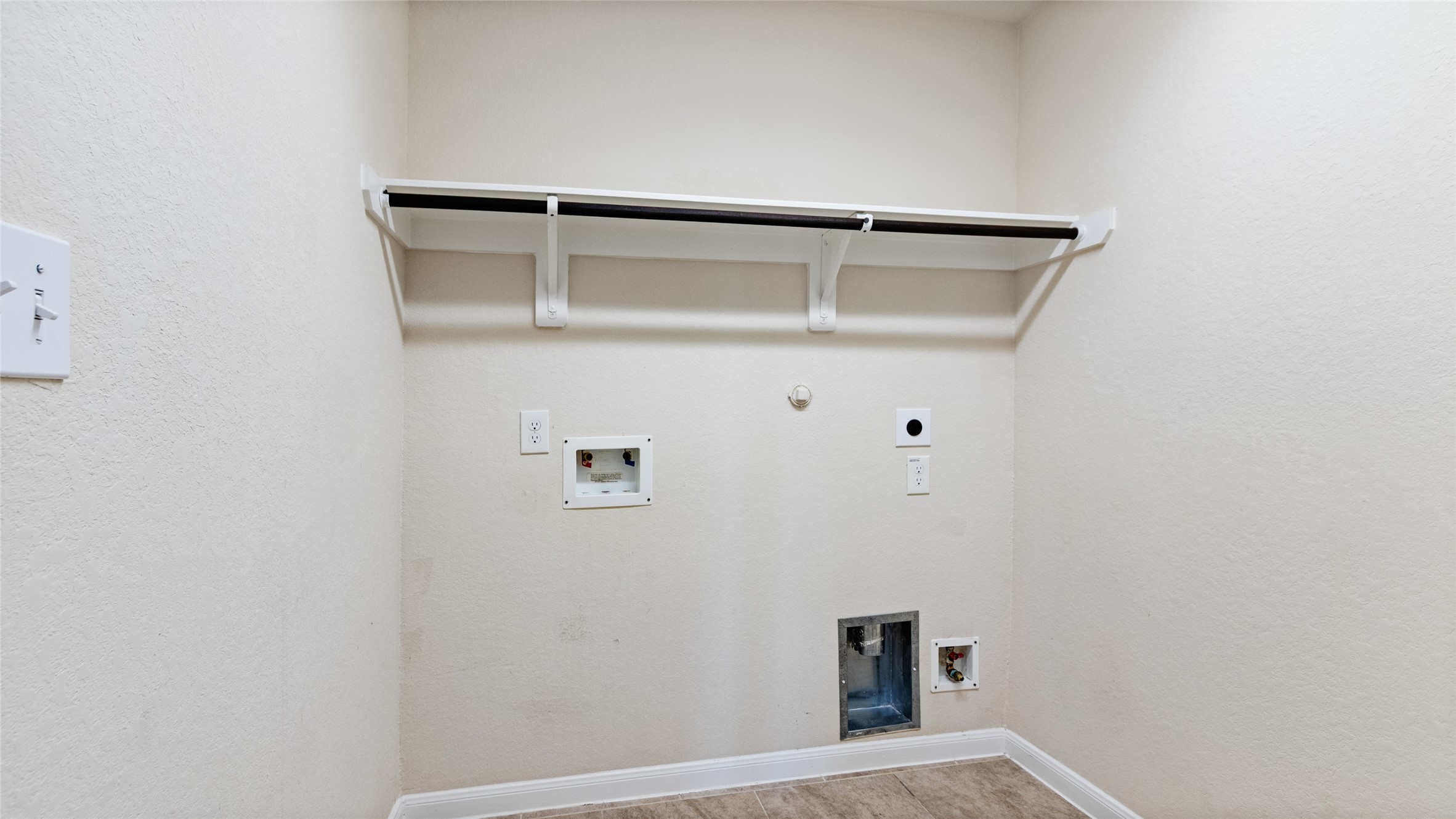 Interior Laundry room with plenty of space for the washer / dryer and a folding table.