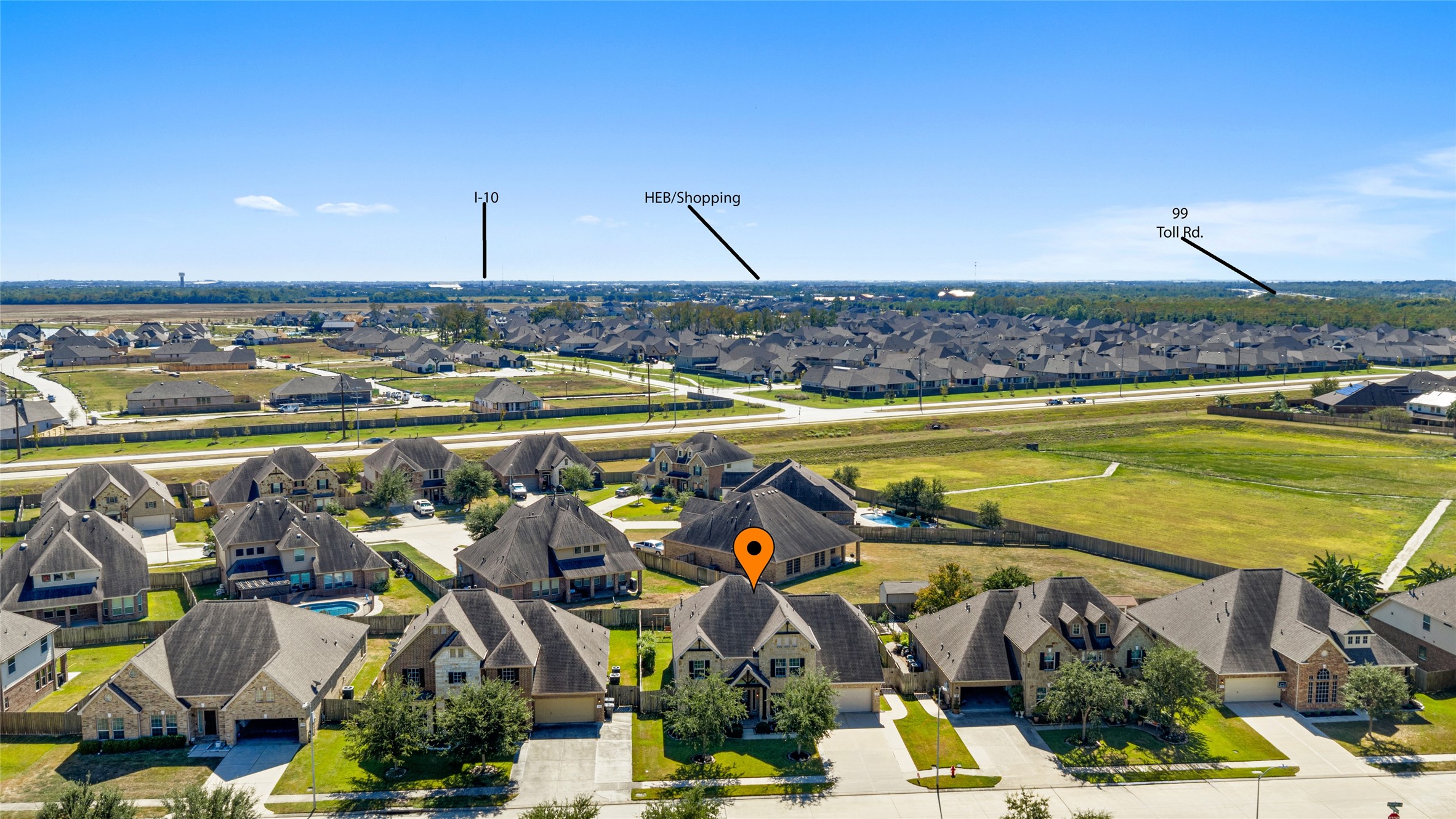 Aerial view highlighting proximity to Grand Parkway (Hwy 99), I-10, and nearby shopping centers, including H-E-B.