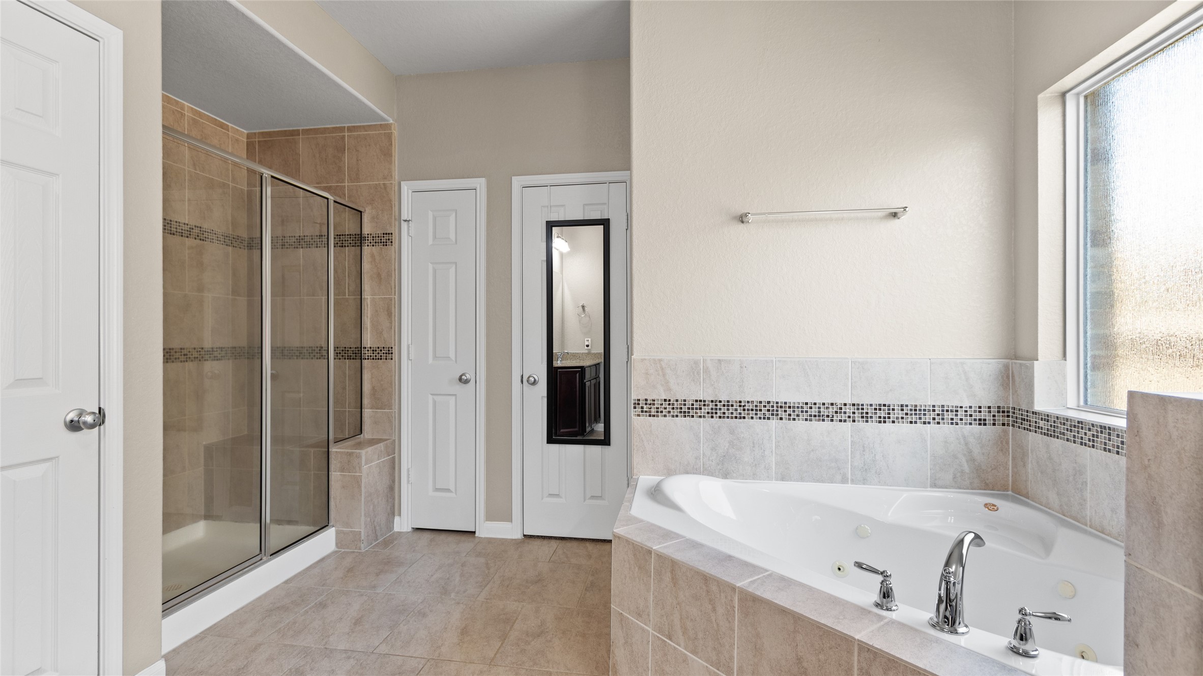 Large stand alone stone and glass shower.