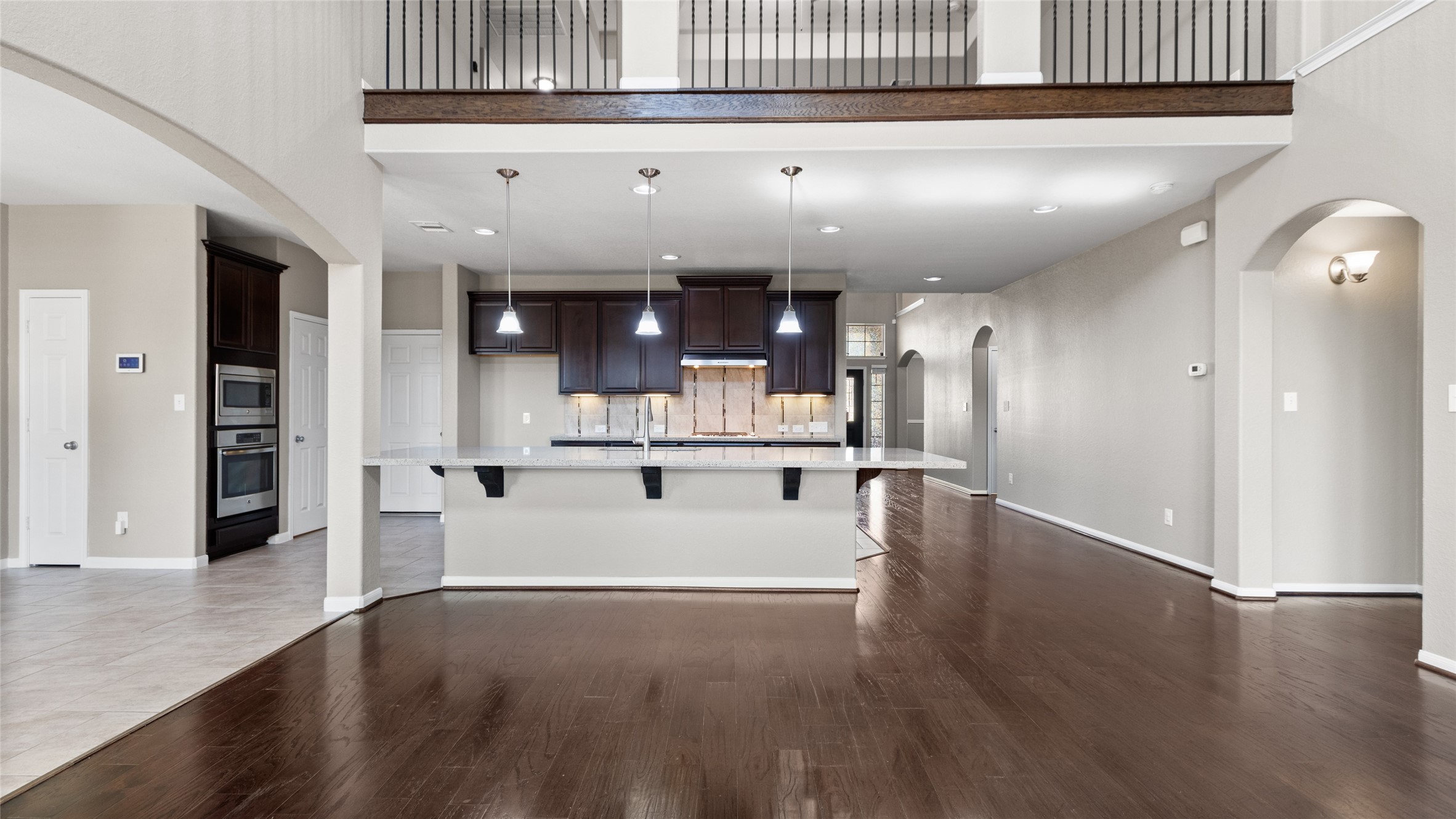 This spacious kitchen features a large center island perfect for entertaining, complemented by bright under-cabinet lighting, stainless steel appliances and a large walk-in pantry which all flows seamlessly into a generously sized breakfast room and sunroom.