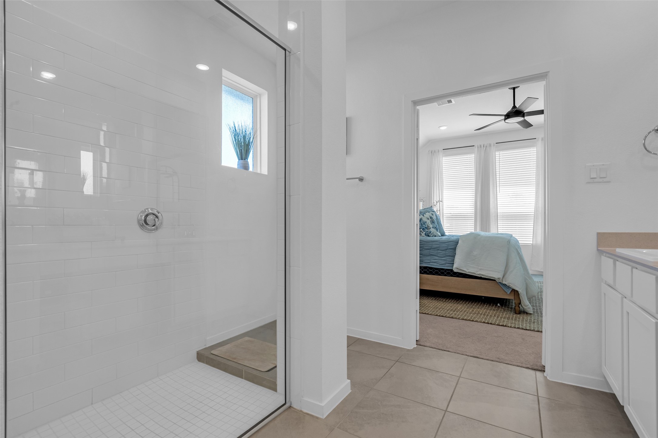 Experience the seamless flow from the elegant bathroom with a spacious glass-enclosed shower to the cozy bedroom, filled with natural light and modern finishes.