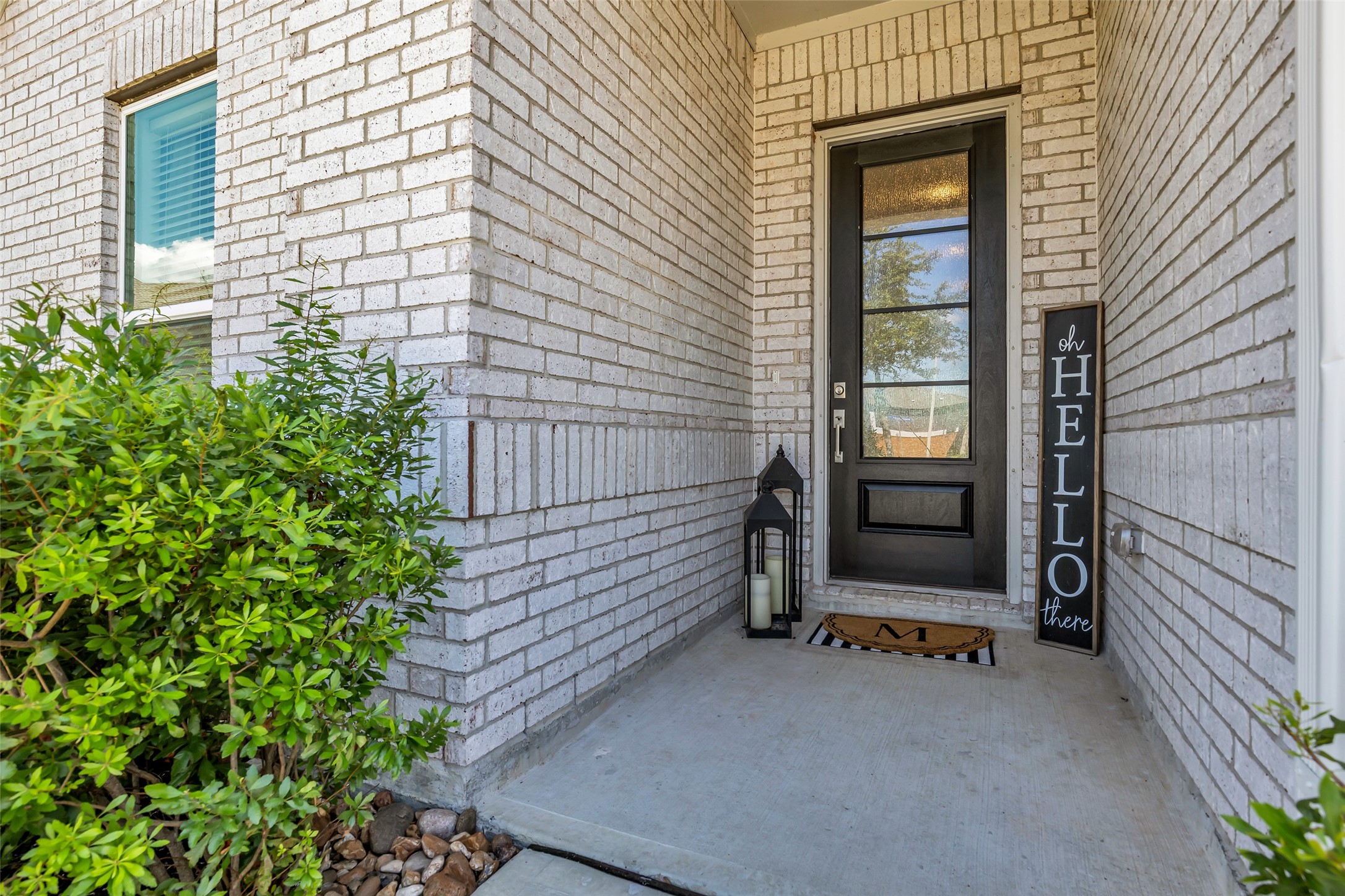 This entryway with a welcoming front door, stylish brickwork, and inviting decor, complemented by lush greenery. This entryway with a welcoming front door, stylish brickwork, and inviting decor, complemented by lush greenery.