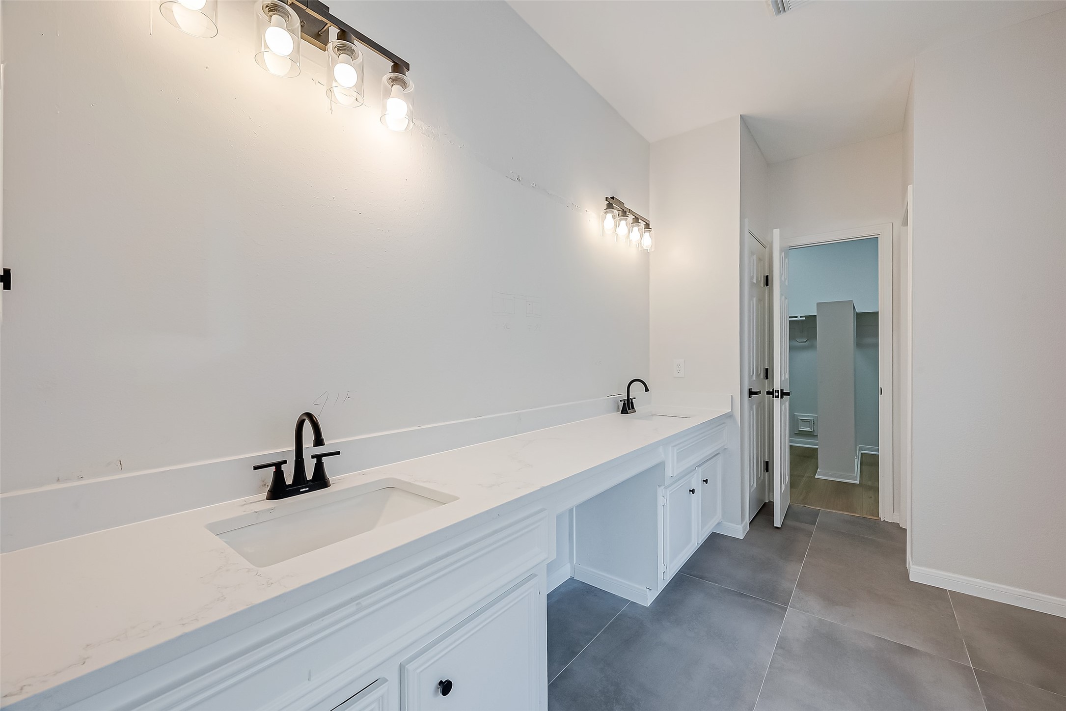 Primary bathroom, mirrors have been installed after photo is taken