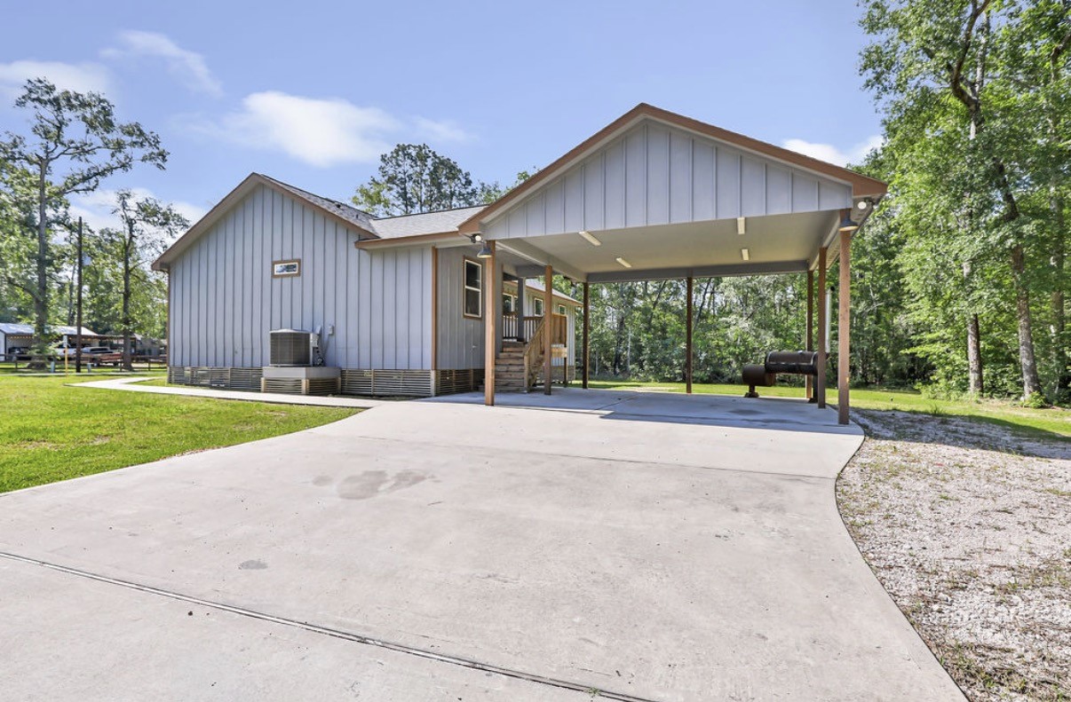 Charming single-story home with a spacious covered double carport, nestled in a serene wooded setting with no back neighbors.