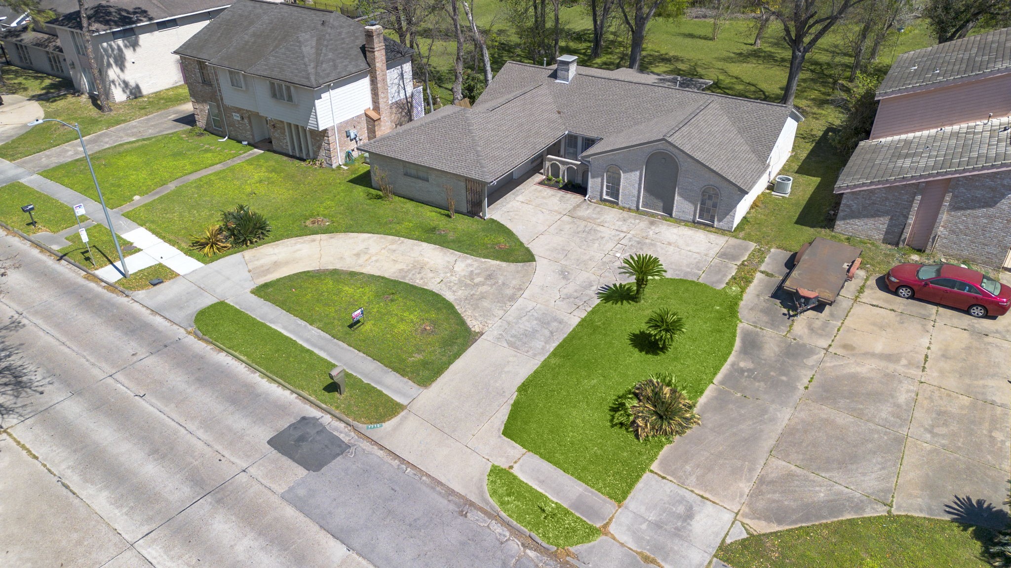 Aerial view of homes shows home large and convent vertical and U shaped driveway