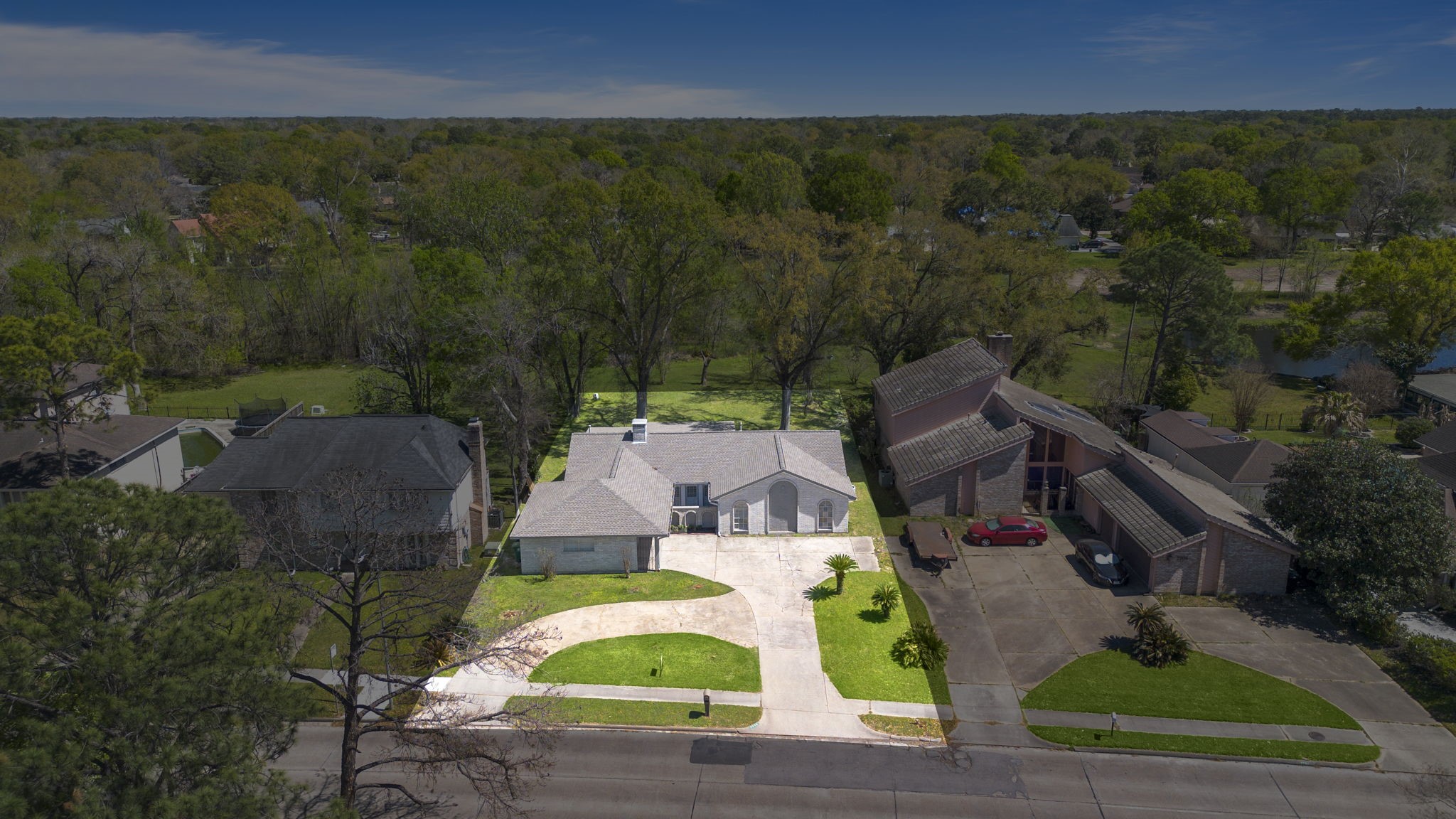 Aerial view of home has a large front and back yard