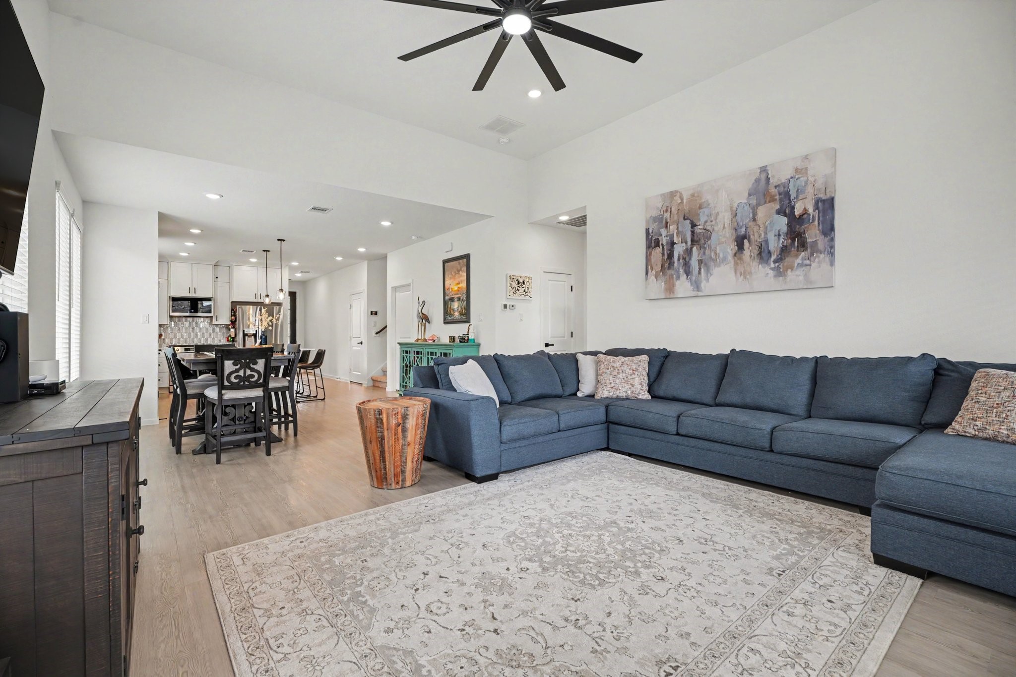 Spacious living room featuring soaring ceilings, expansive windows, and an open design that enhances the home's bright and airy feel.