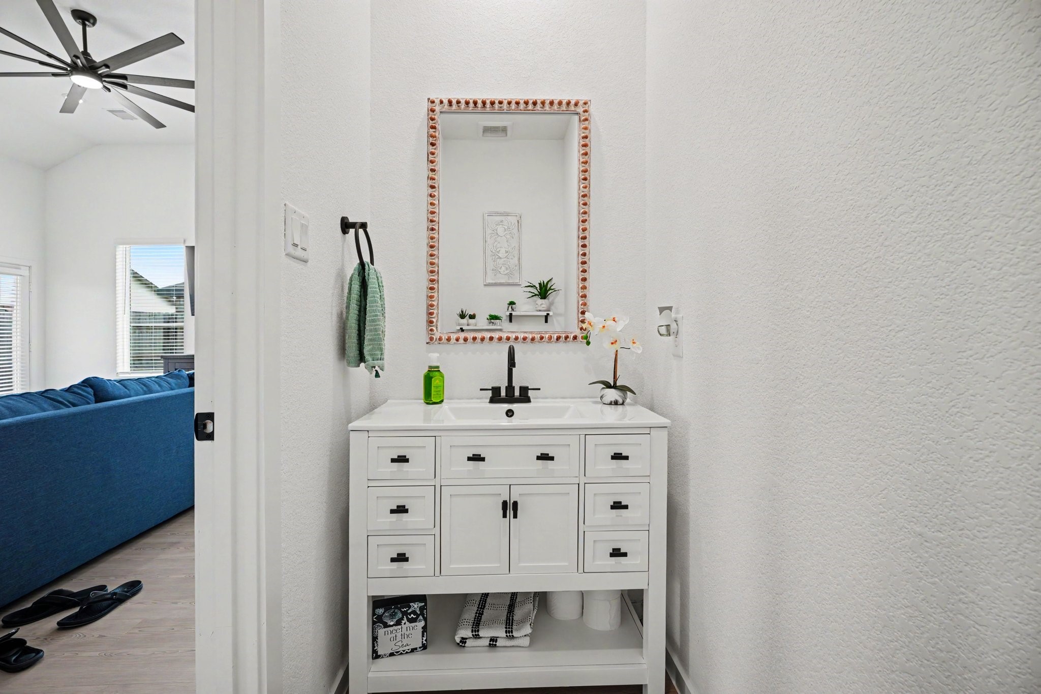 Convenient first-floor half bathroom featuring an updated vanity and modern fixtures.