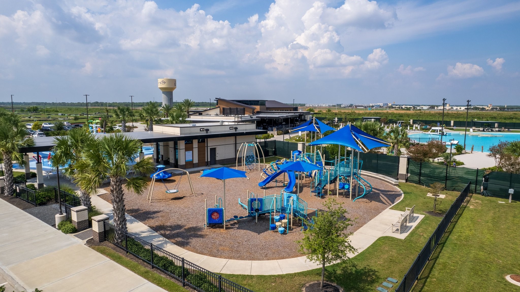 Community playground featuring shaded play structures, swings, and family-friendly outdoor recreation areas.