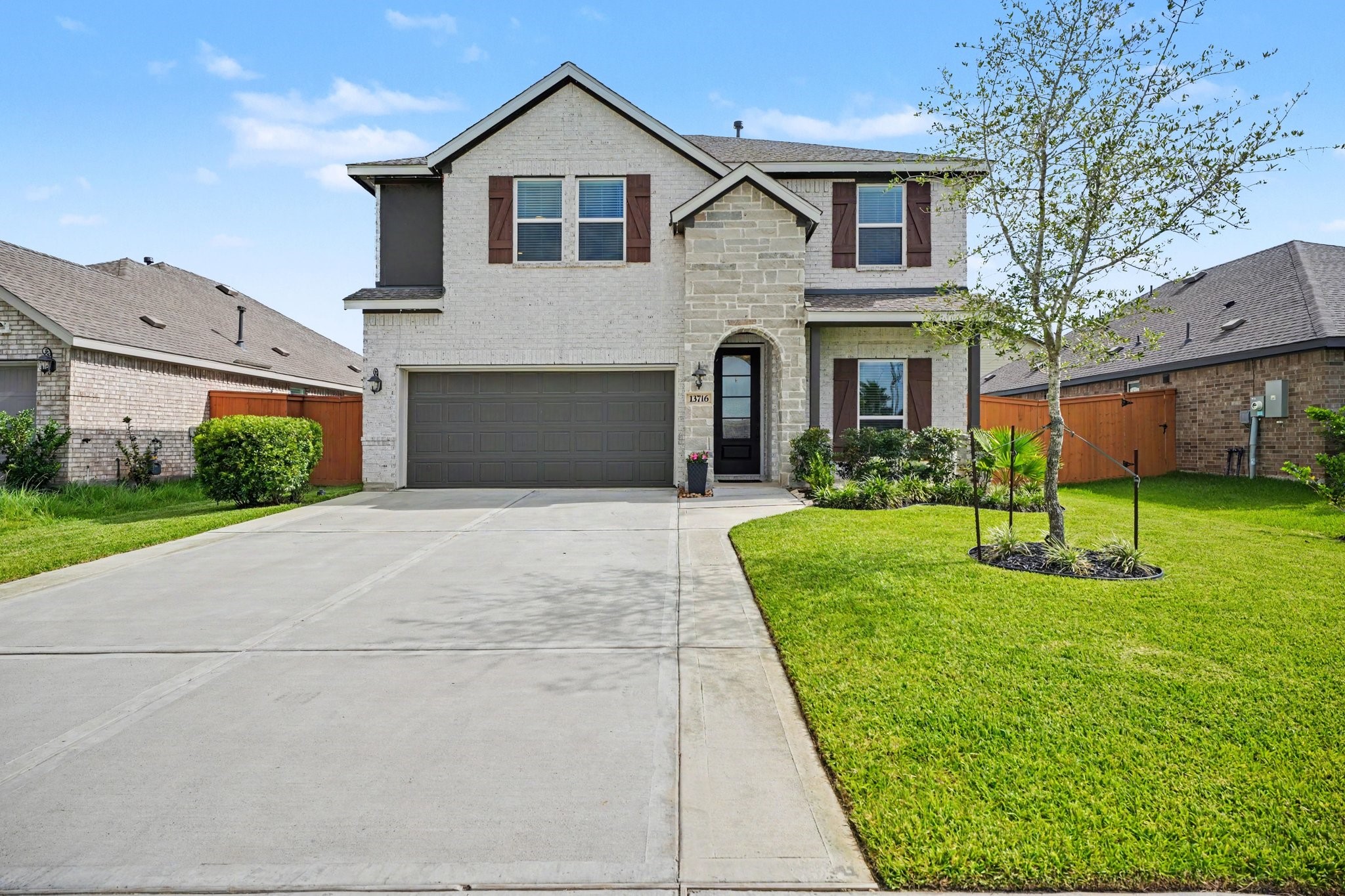 Beautiful two-story brick and stone elevation with a spacious driveway, manicured landscaping, and inviting curb appeal. Beautiful two-story brick and stone elevation with a spacious driveway, manicured landscaping, and inviting curb appeal.