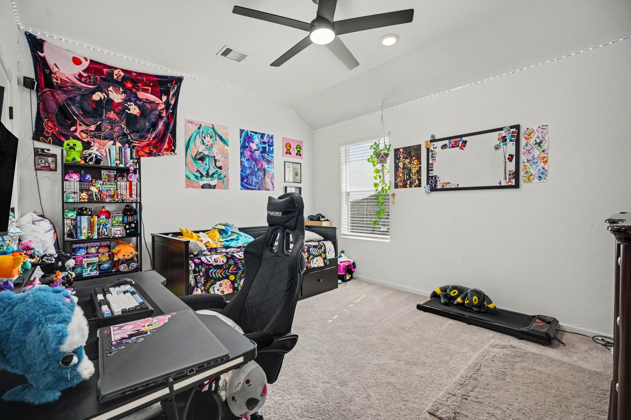 Additional bedroom offering a bright, open feel with vaulted ceilings and ample floor space.