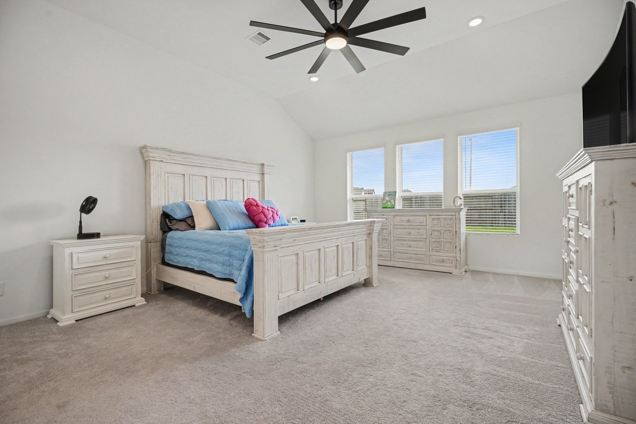 Spacious primary suite featuring high ceilings, generous proportions, and large windows that fill the room with natural light.