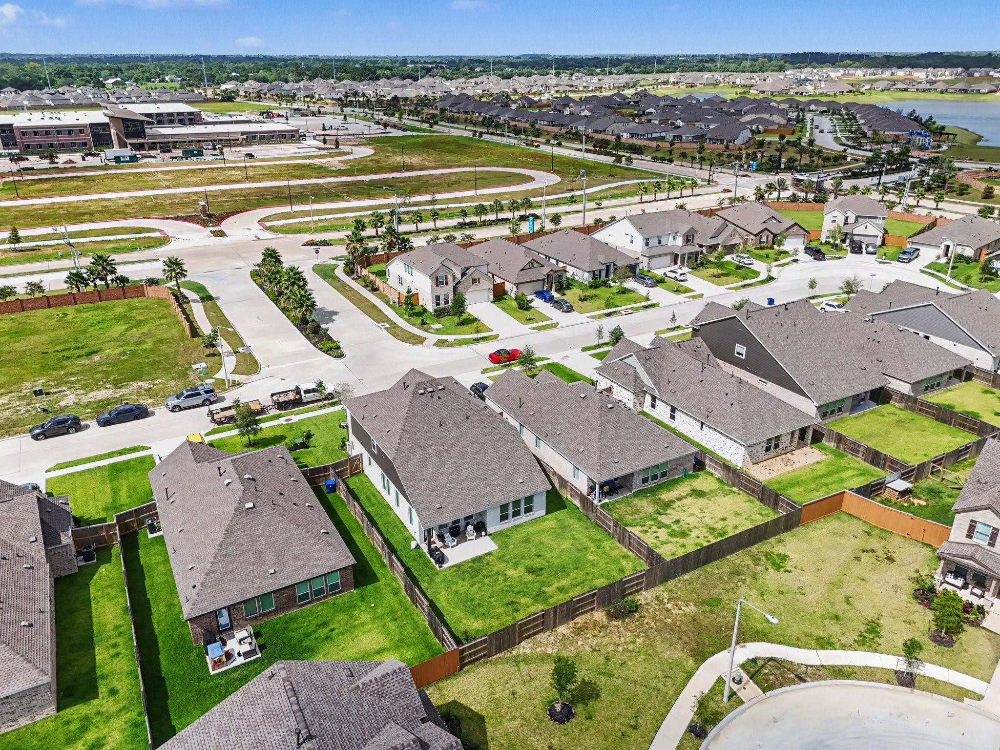 Rear aerial view highlighting the oversized backyard and the home's location within this growing master-planned community.