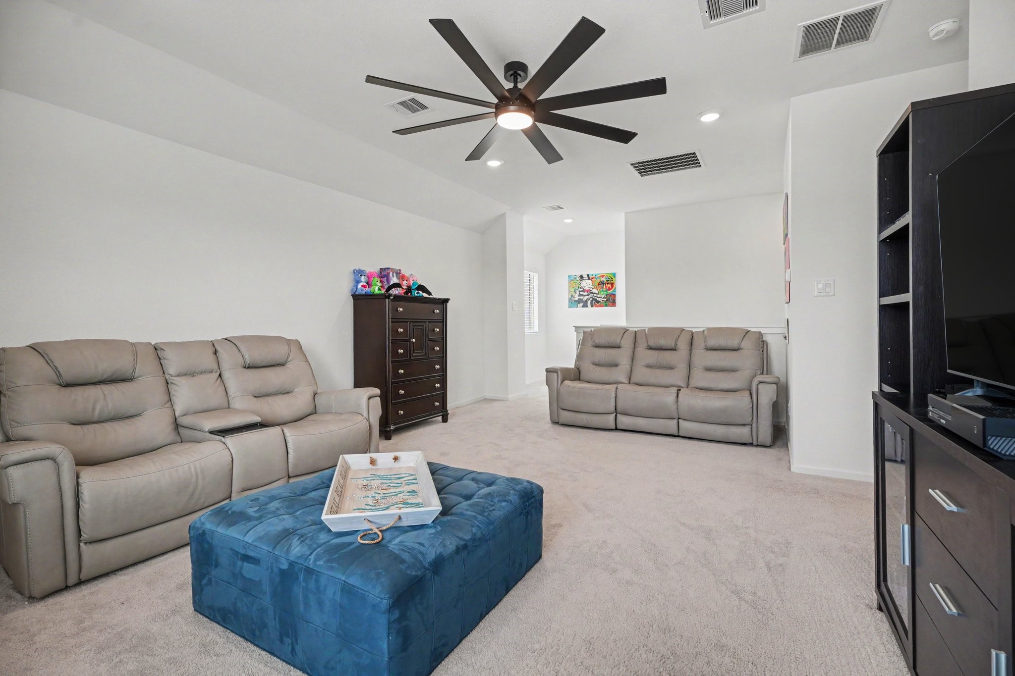 Spacious upstairs game room with vaulted ceilings, recessed lighting, and plenty of room for media, recreation, or gathering space.