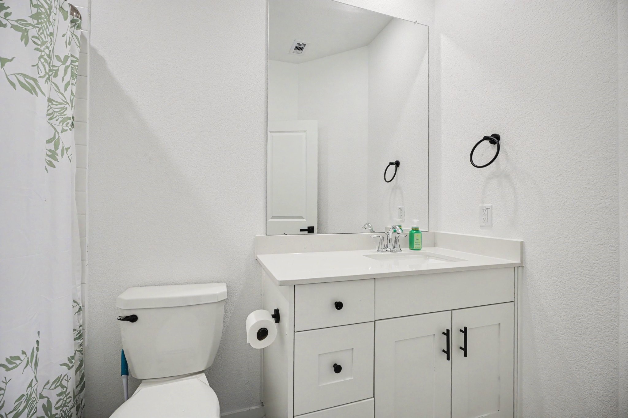 Secondary bathroom featuring a vanity with storage, updated fixtures, and a tub/shower combination.