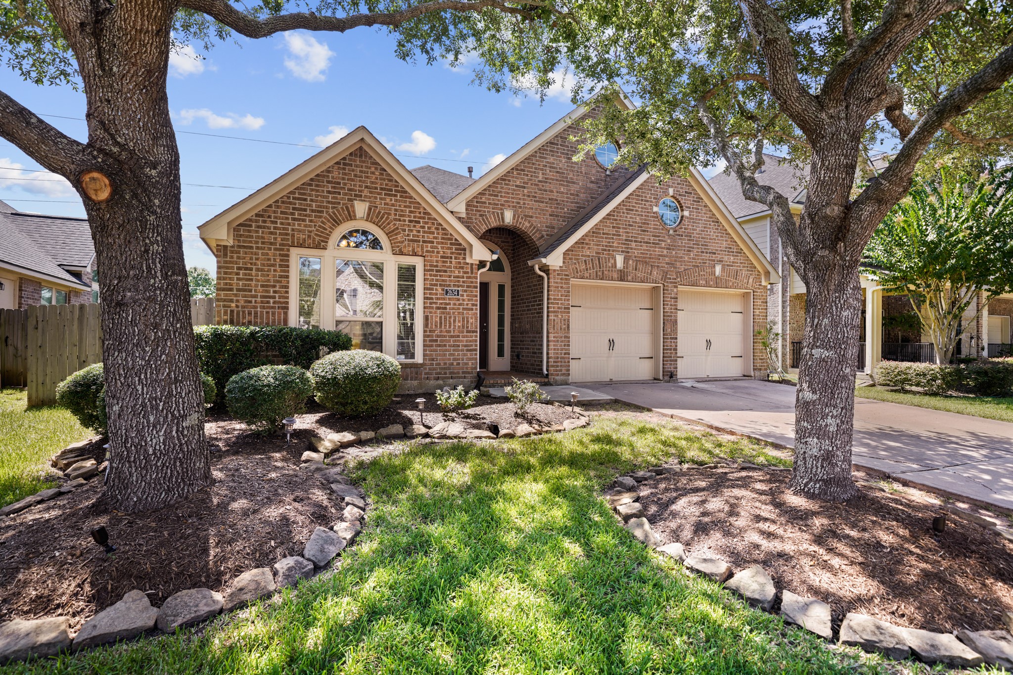 Beautiful brick elevation framed by mature shade trees with inviting curb appeal and a spacious two-car garage. Beautiful brick elevation framed by mature shade trees with inviting curb appeal and a spacious two-car garage.