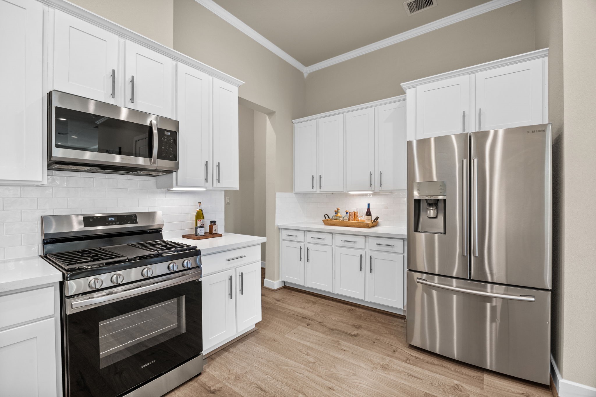 All appliances (including washer/dryer) convey with the property. The hallway to the left leads to the attached garage. There is space to add additional storage or even a bench for a MUD nook, if desired.