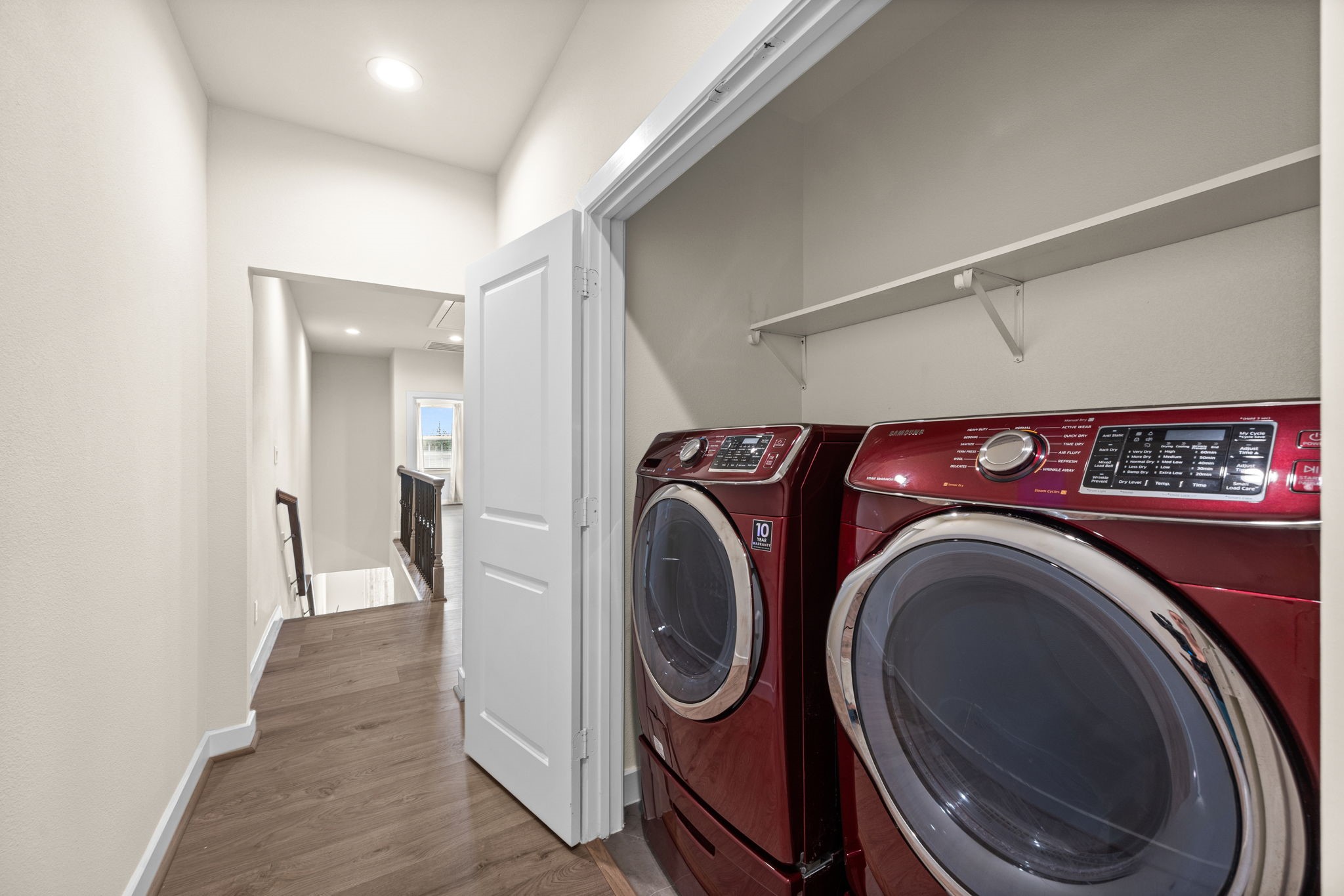 Laundry is centrally located on the 2nd floor, between the primary and secondary bathrooms.
