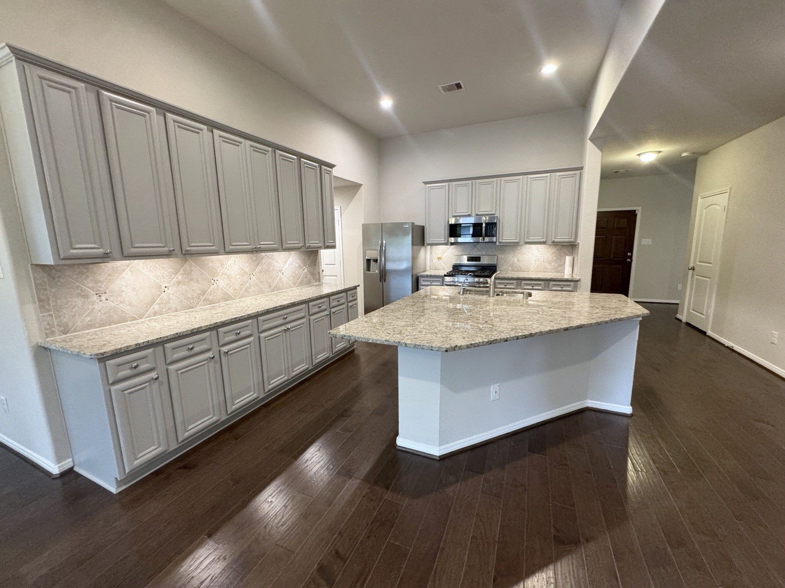Lots of cabinets and countertop space in this large open kitchen