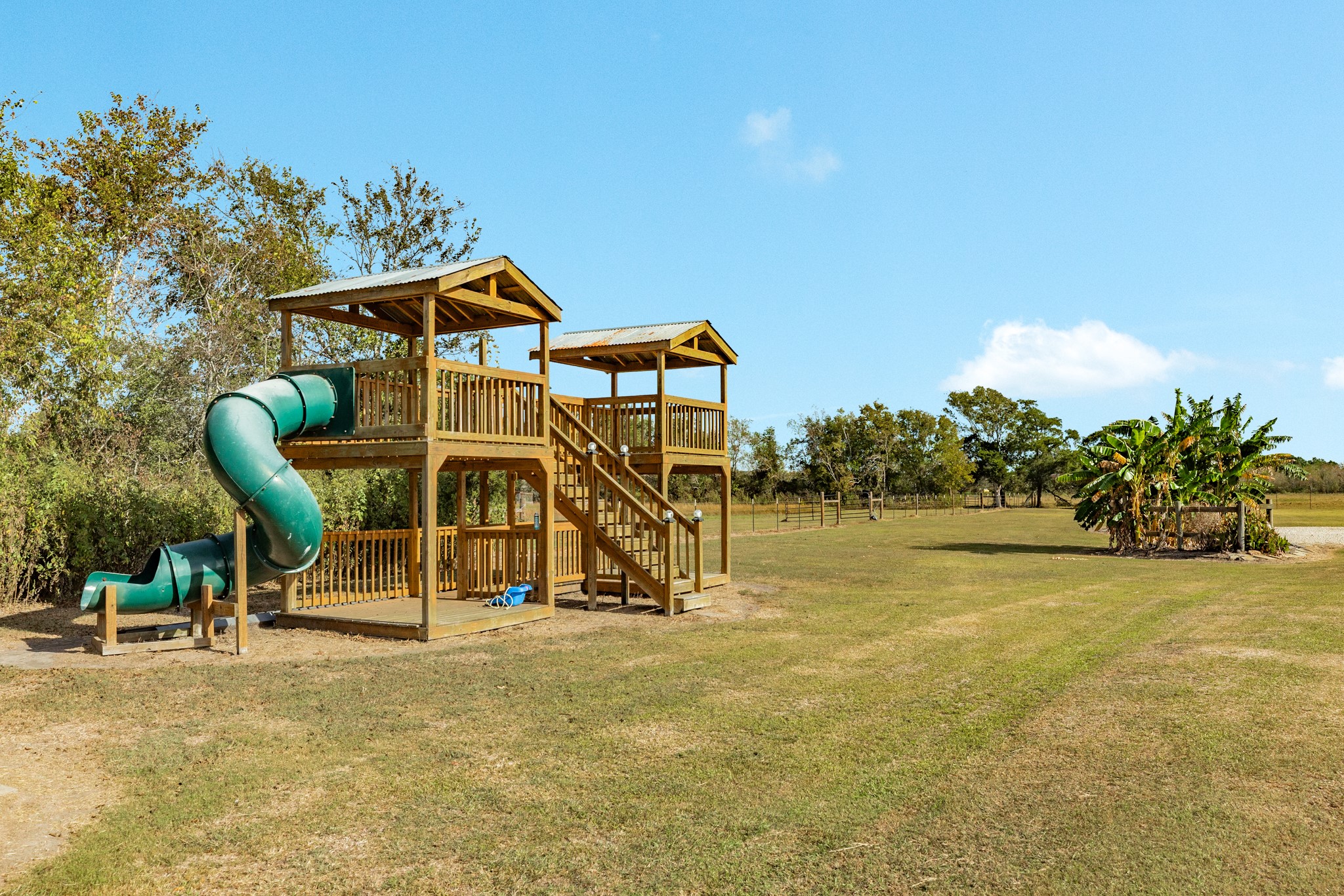 Outdoor play area with custom wooden play structure.