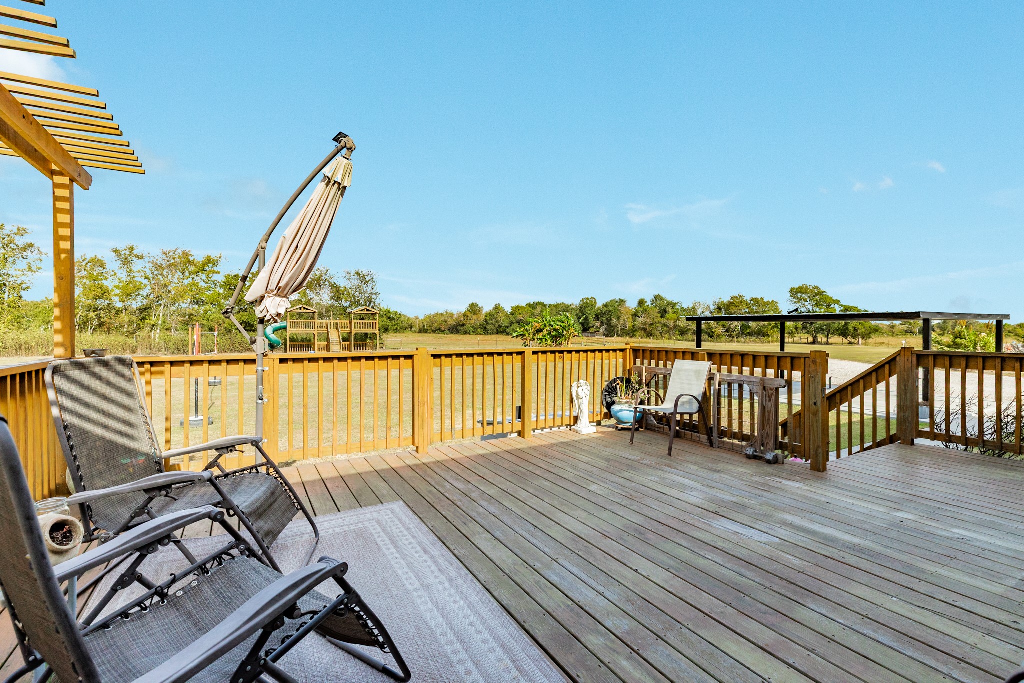 Large wooden deck overlooking the acreage.