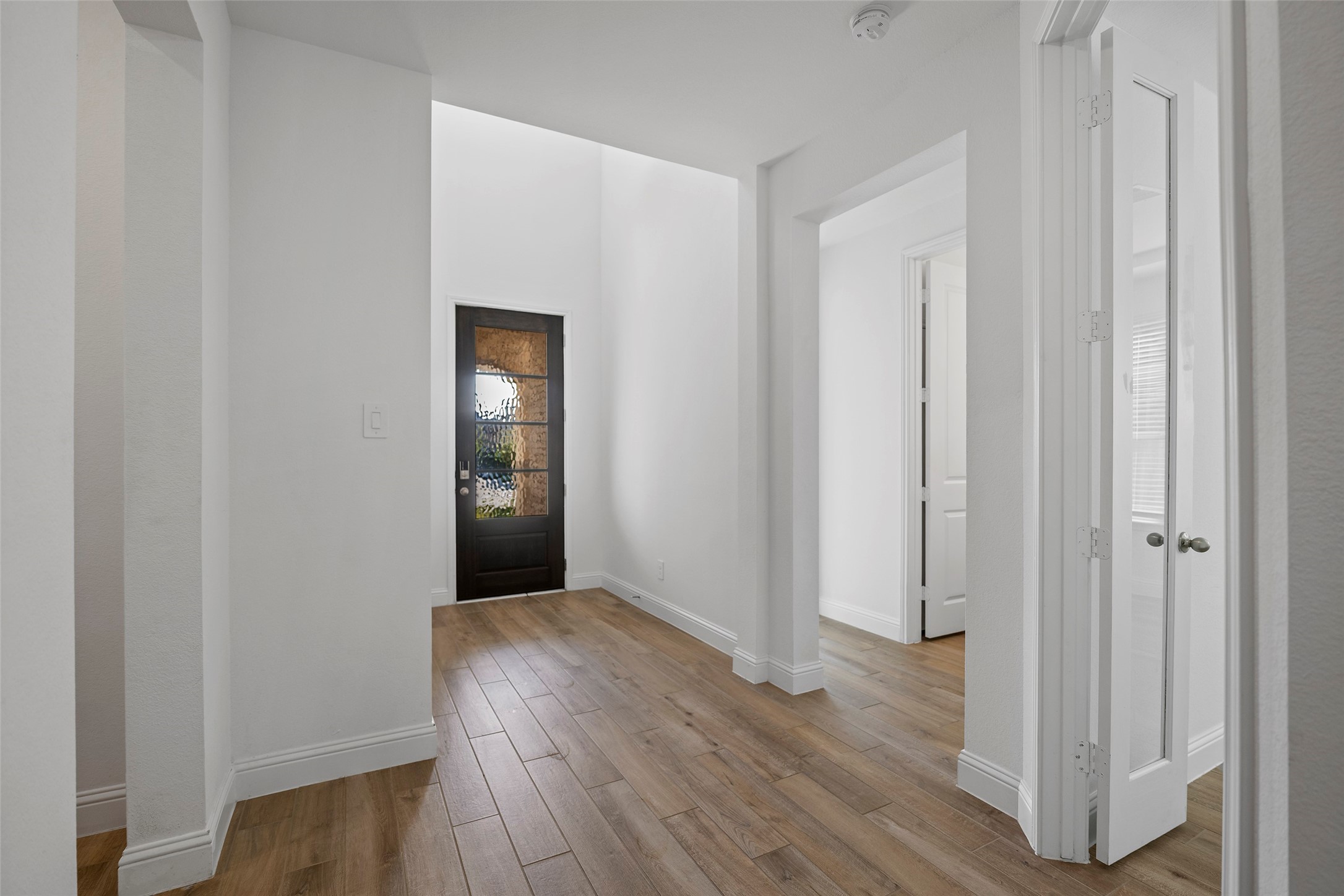 A view of the entryway.  Just off to the right is Bedroom #2 downstairs, A Full Bath and thru the double glass doors is the Study.