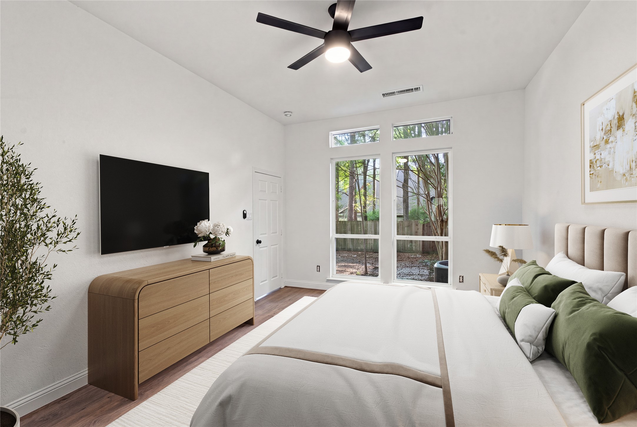 Floor-to-ceiling windows bring plenty of natural light into the second bedroom. Virtually staged for layout purposes.