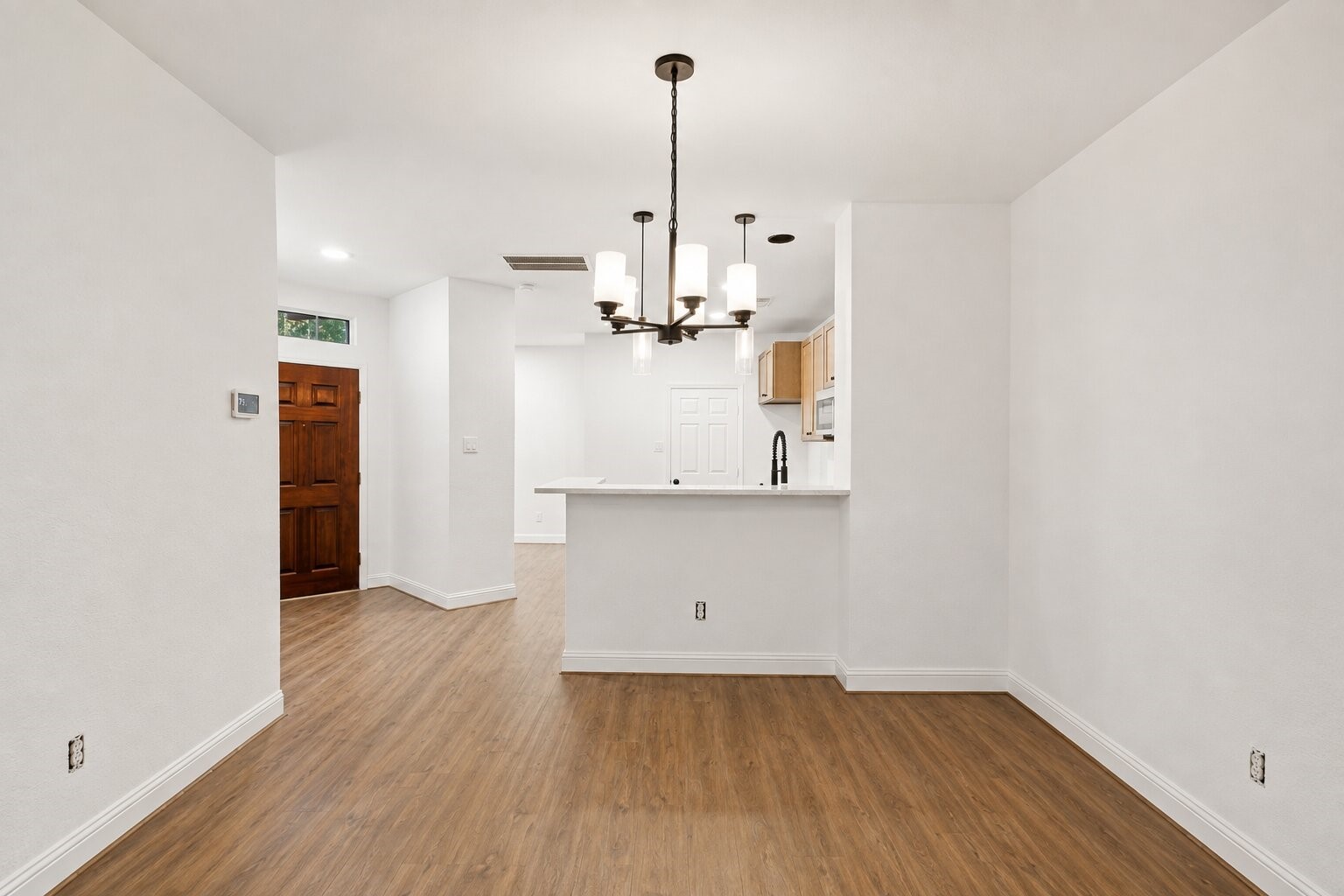 Spacious dining area with an open view into the kitchen and breakfast bar.