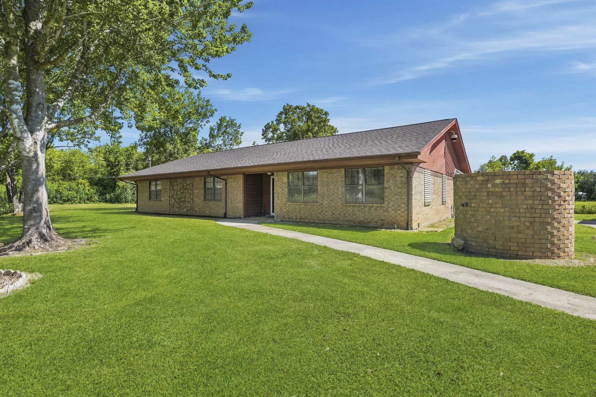 Charming brick ranch-style home nestled on a spacious, lush lawn with mature trees offering shade and privacy. Charming brick ranch-style home nestled on a spacious, lush lawn with mature trees offering shade and privacy.