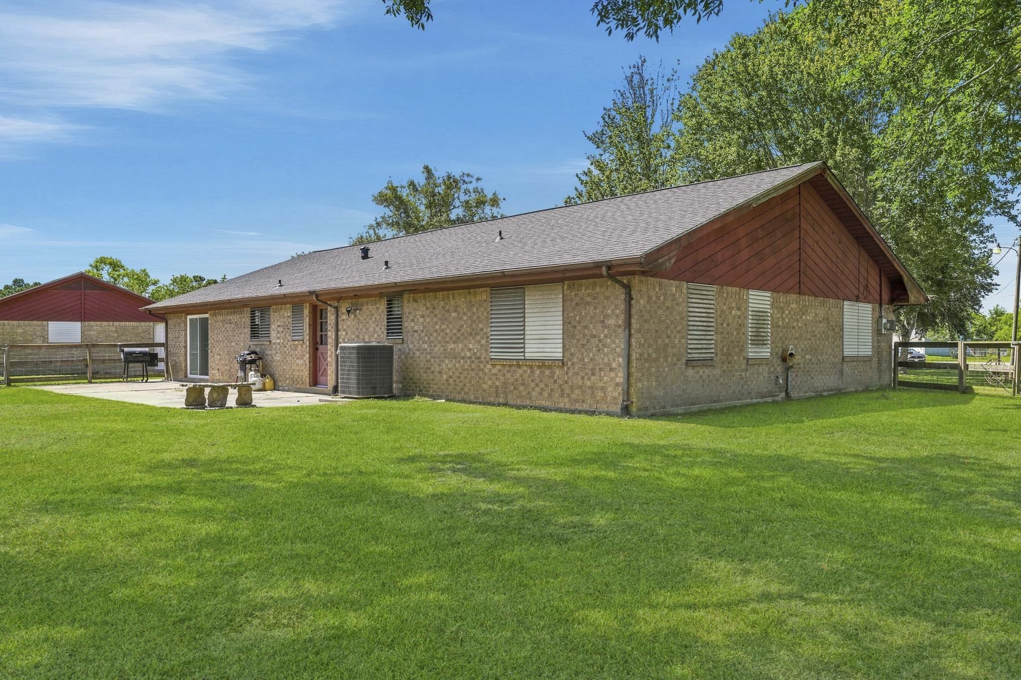 Charming brick home with a spacious backyard, perfect for outdoor gatherings and relaxation.