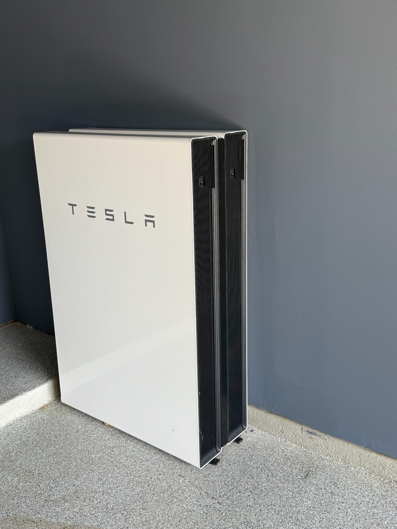 Energy-efficient garage equipped with a Tesla battery bank.