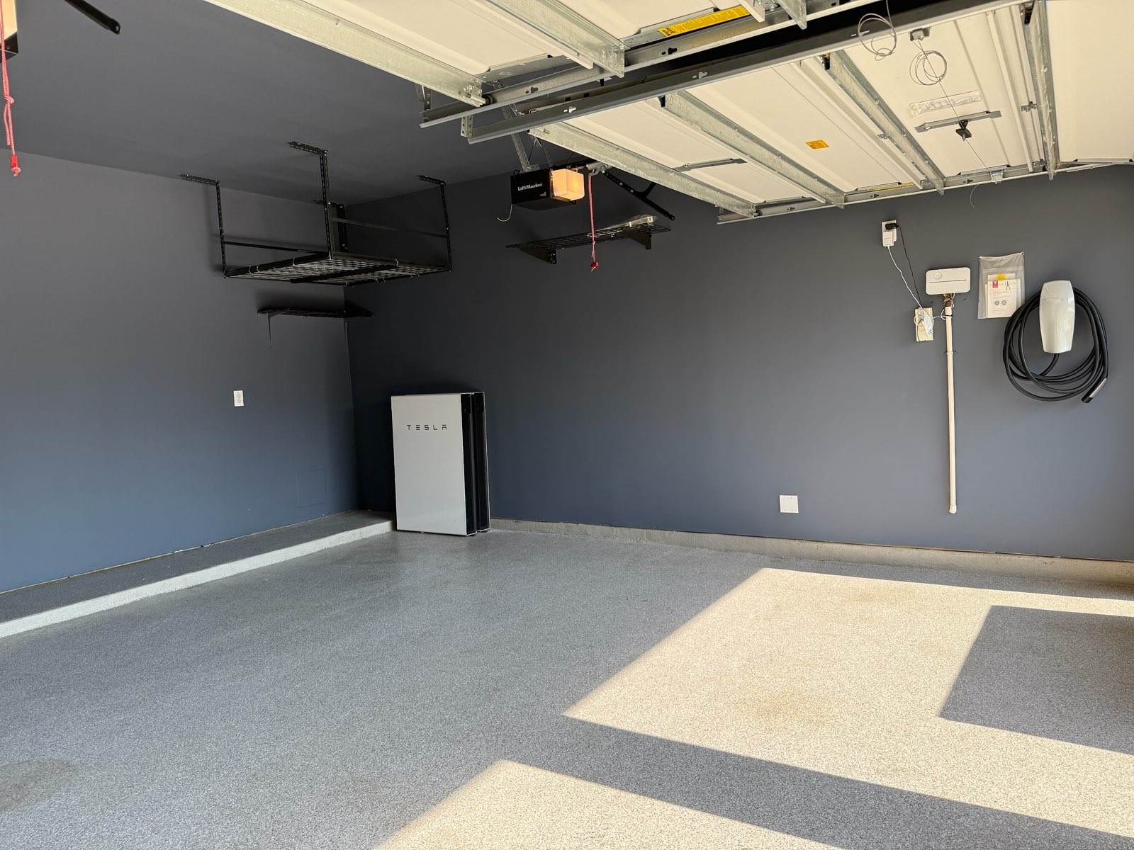 Sleek garage with durable epoxy flooring.