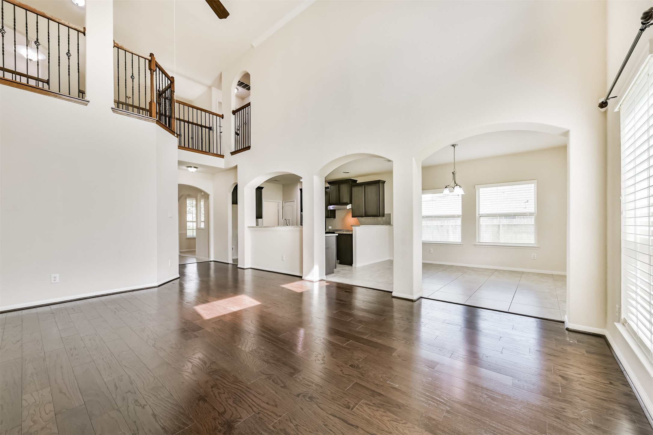 Spacious and bright living area with high ceilings, elegant flooring, and seamless flow into the kitchen and dining spaces. Perfect for entertaining!
