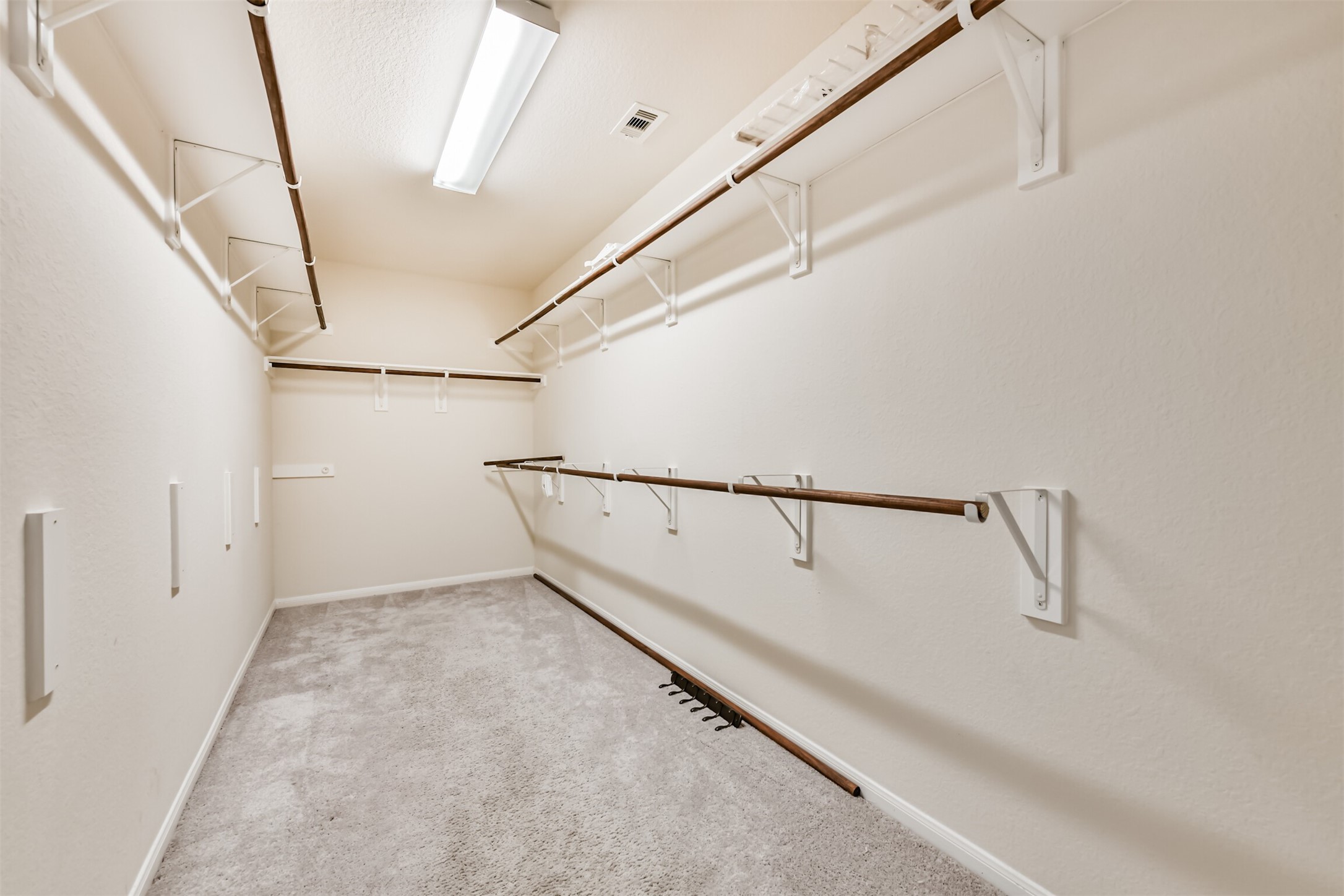 Spacious walk-in closet with ample storage for all your wardrobe needs.