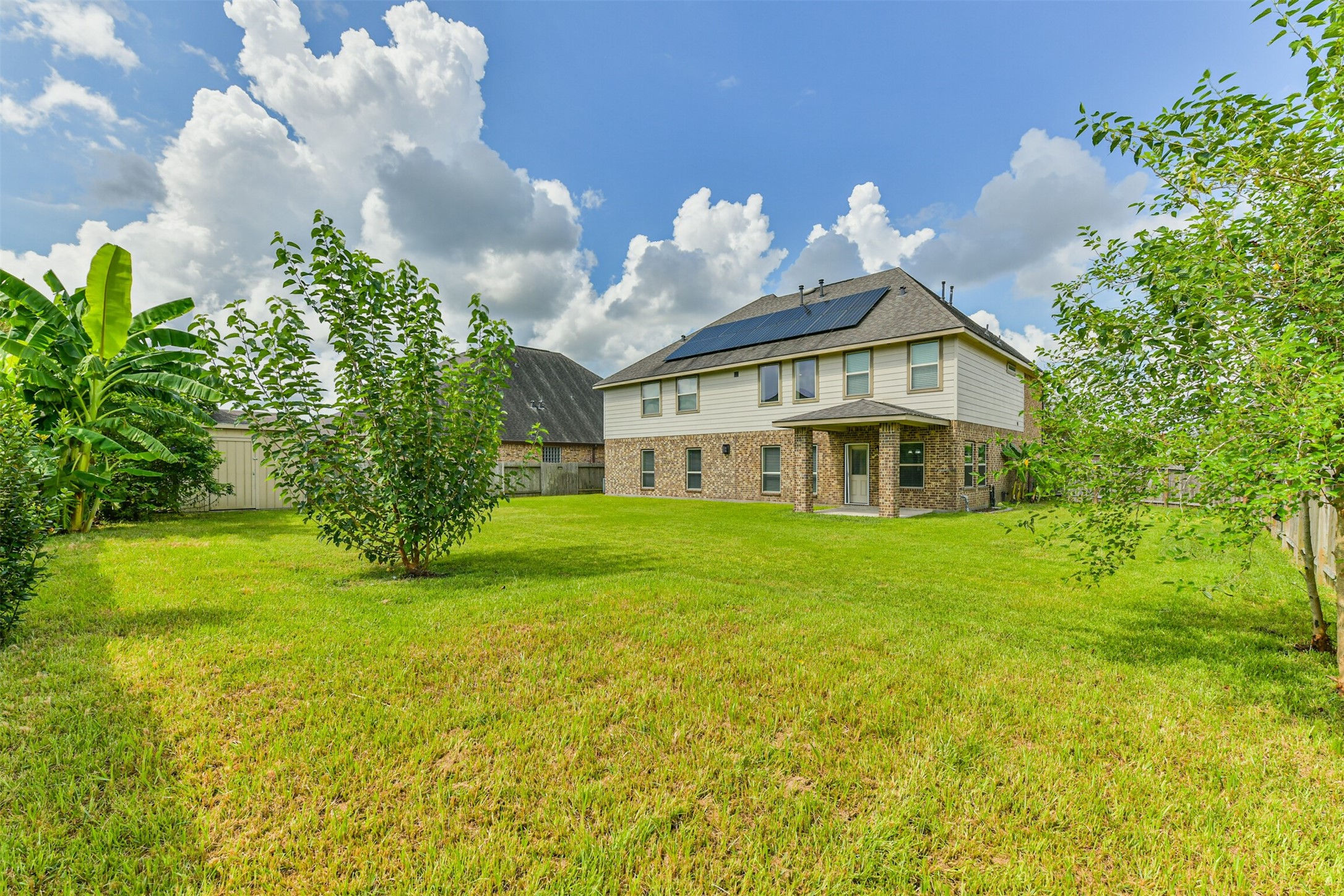 This spacious backyard is perfect for entertaining, gardening, playing, or simply relaxing under the open sky.