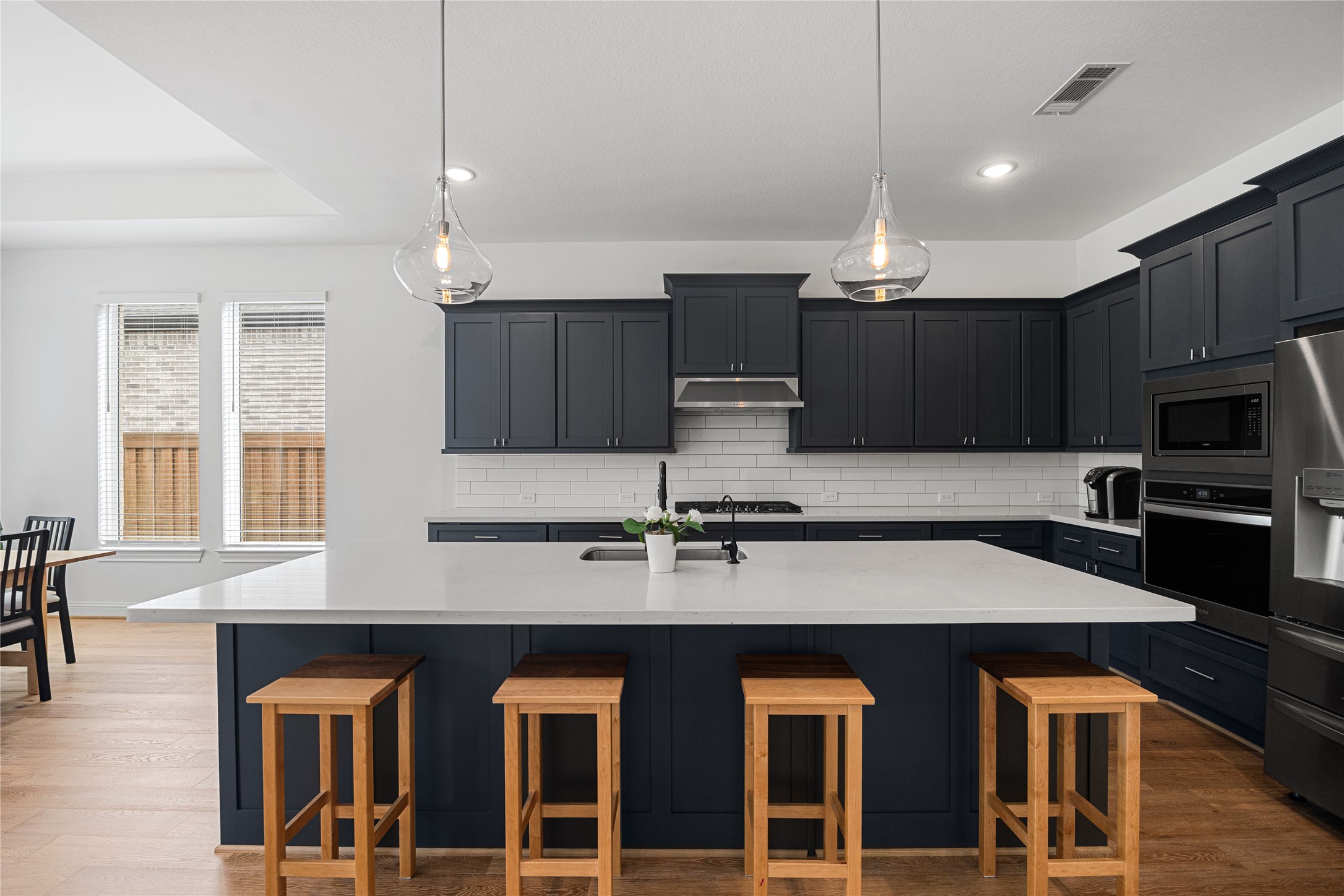 Chef's Kitchen with shaker-style cabinets hardware and an oversized island.
