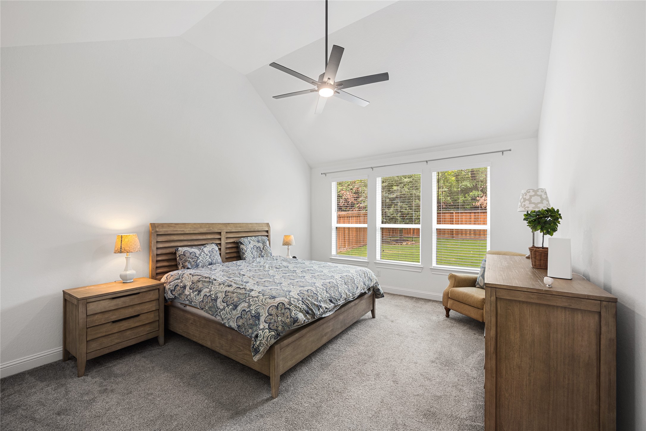 Primary bedroom with high ceilings and ensuite bathroom.