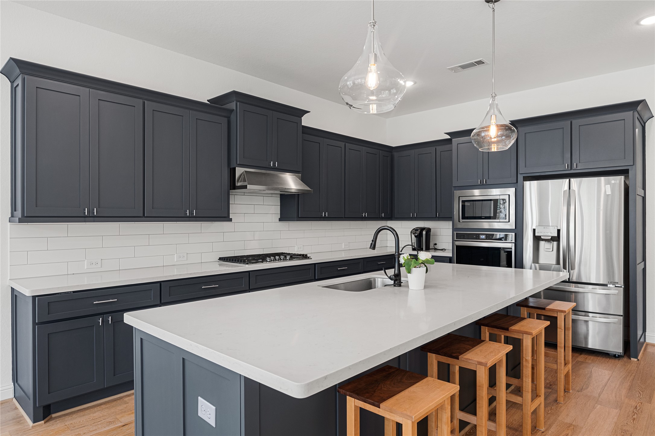 Chef's Kitchen with shaker-style cabinets hardware and an oversized island.