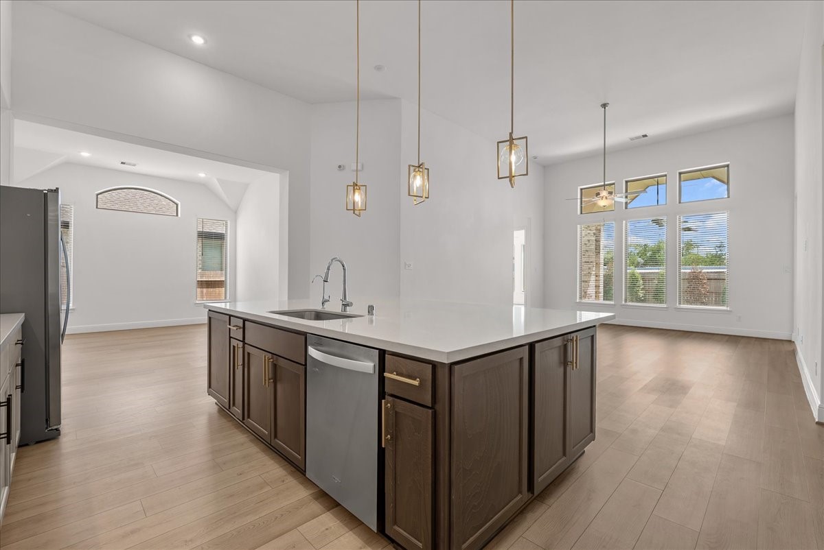 The beautifully appointed kitchen opens seamlessly to the living room and features an oversized island, stainless steel appliances, and 42-inch cabinetry with crown molding.