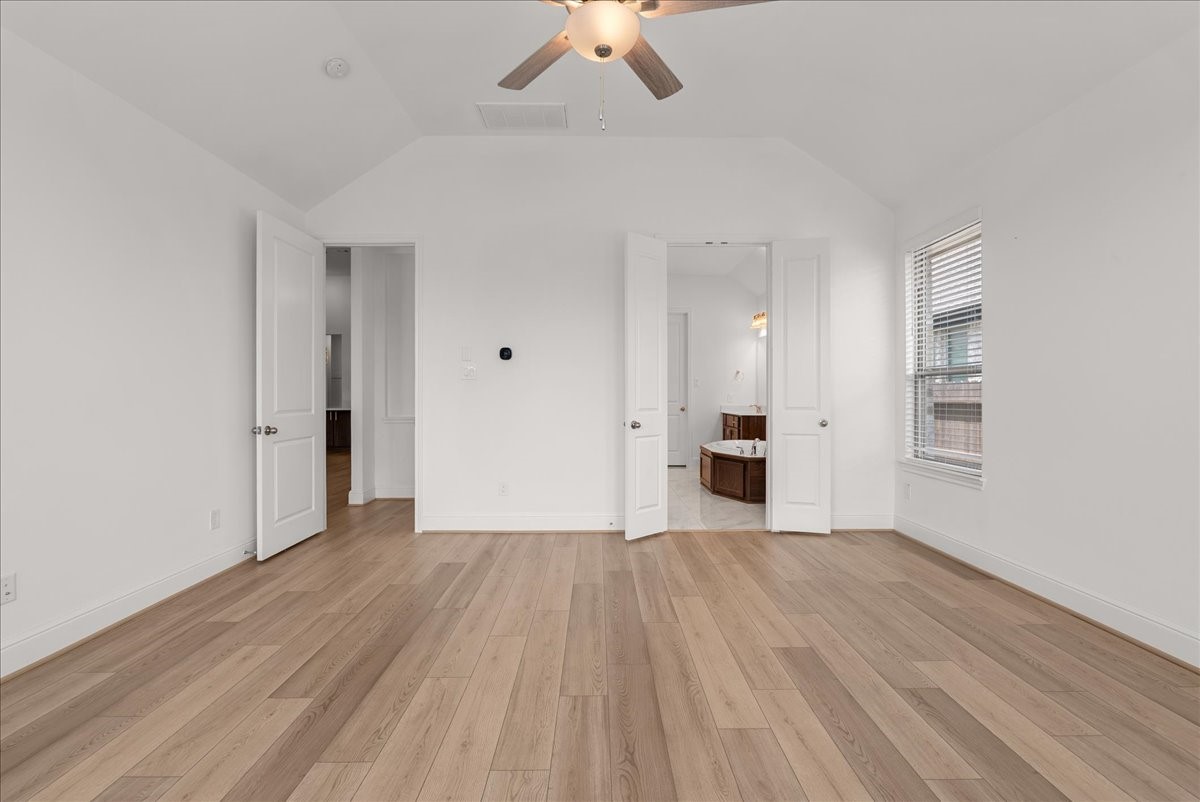 he secluded primary retreat boasts a spa-inspired en-suite bath with dual vanities, soaking tub, walk-in shower, and generous walk-in closet.