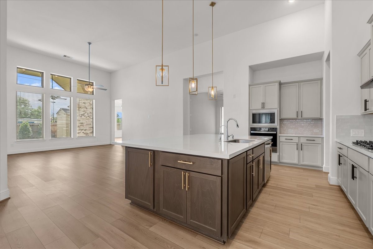 The beautifully appointed kitchen opens seamlessly to the living room and features an oversized island, stainless steel appliances, and 42-inch cabinetry with crown molding.
