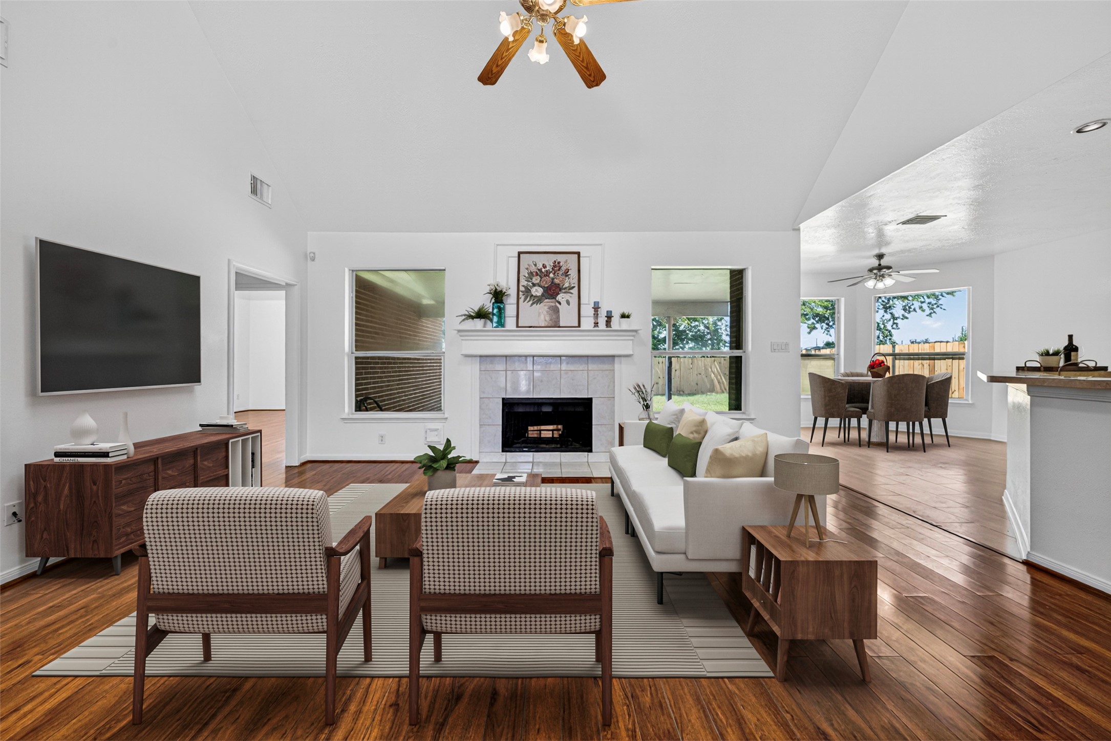 The living room serves as the heart of the home, featuring a stunning fireplace and an open-concept layout that overlooks the kitchen