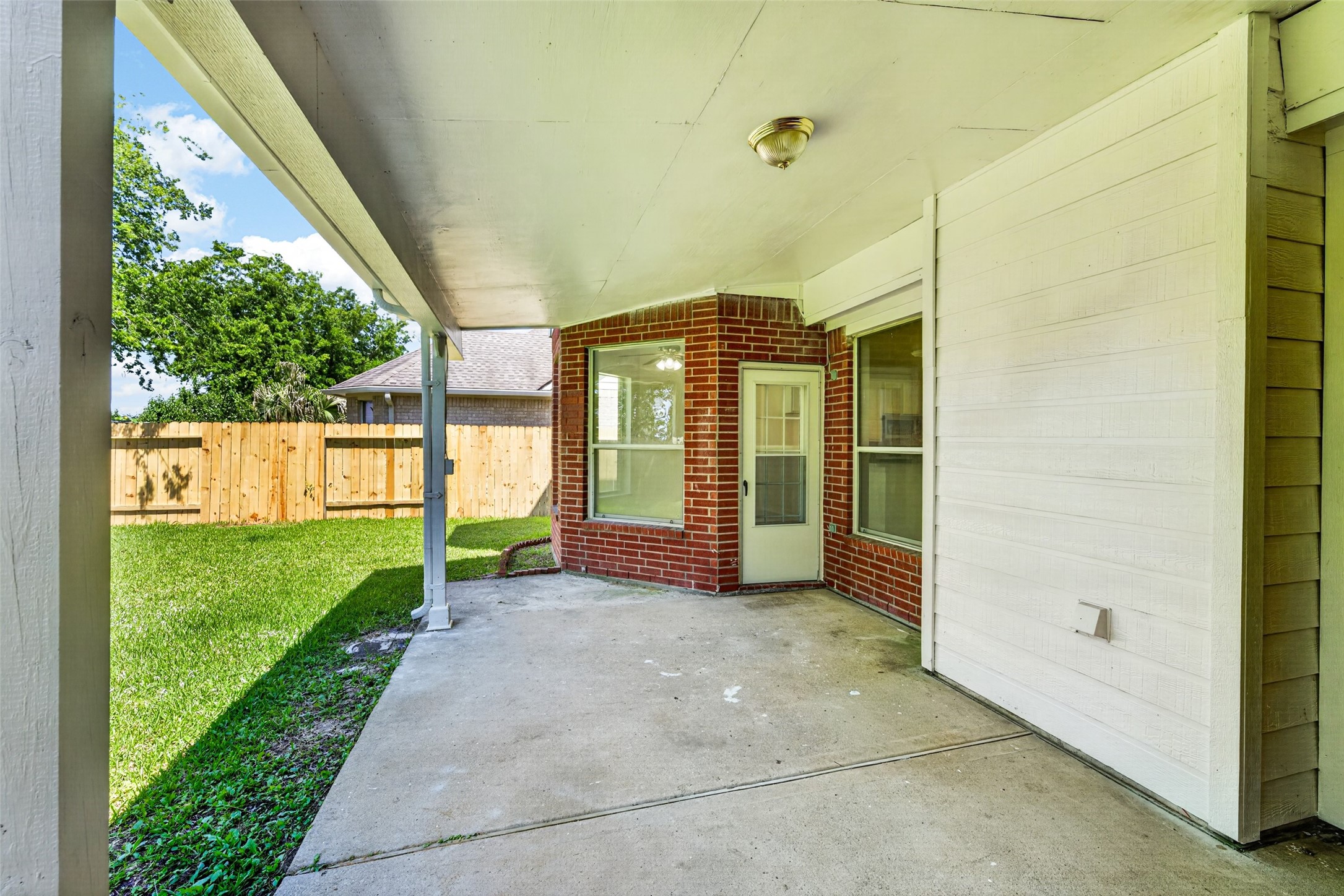 Step out onto the spacious covered patio, an ideal spot for outdoor lounging or dining while enjoying the privacy of a backyard with no back neighbors.
