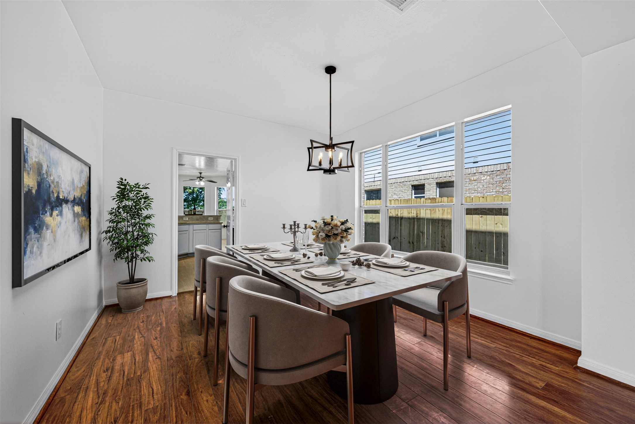 The formal dining area is a bright and inviting space, highlighted by a large window that frames views of the private backyard.