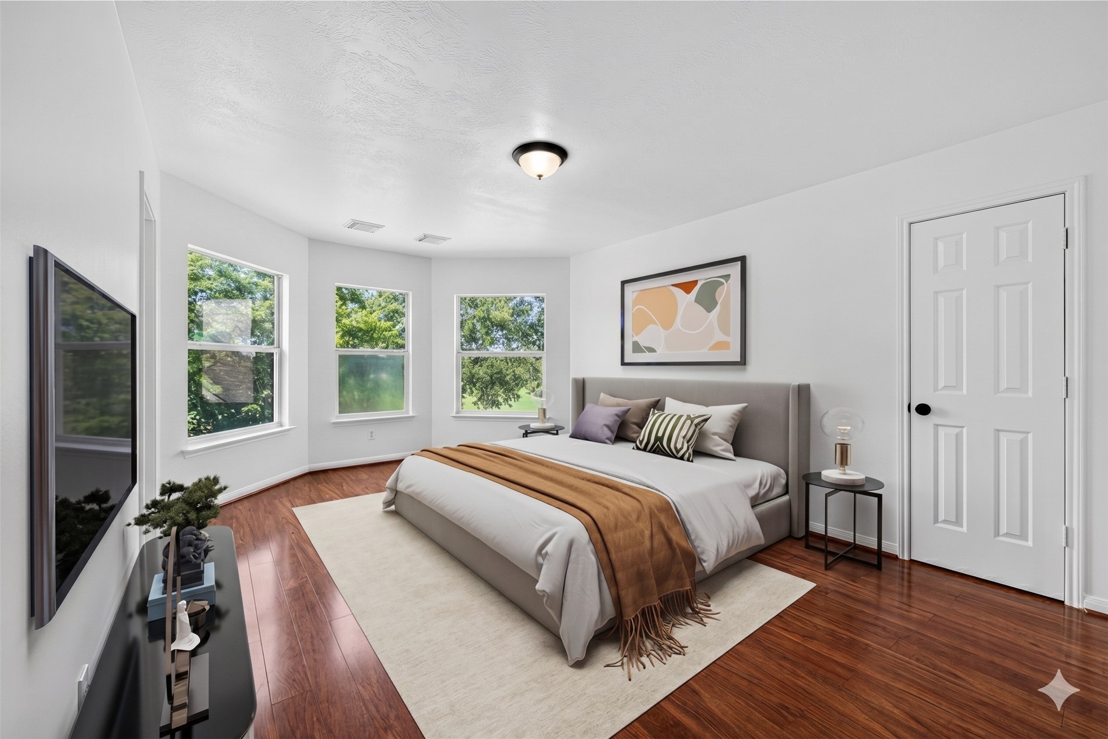 The second bedroom is notably cheerful, filled with large windows that radiate positive vibes and plenty of natural light