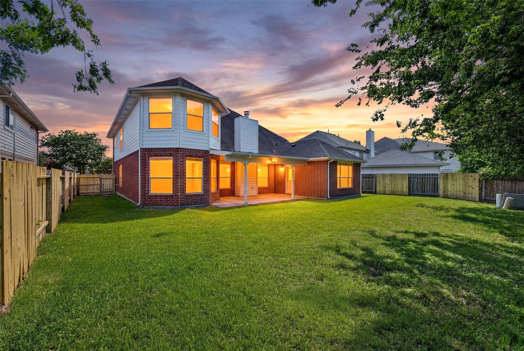 The backyard serves as a private oasis, filled with mature trees that provide refreshing shade for outdoor relaxation.