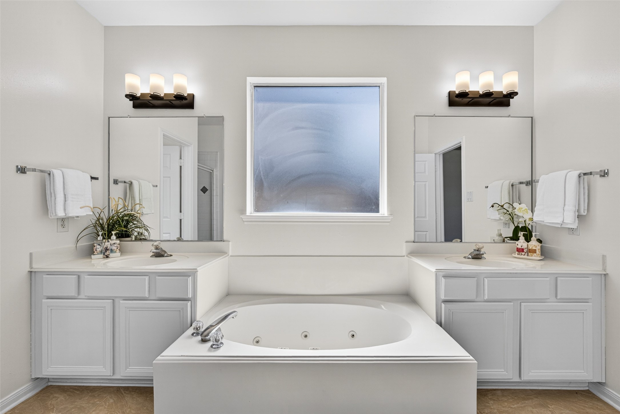 It features an en suite bathroom complete with a relaxing garden tub and a dual vanity for morning convenience.