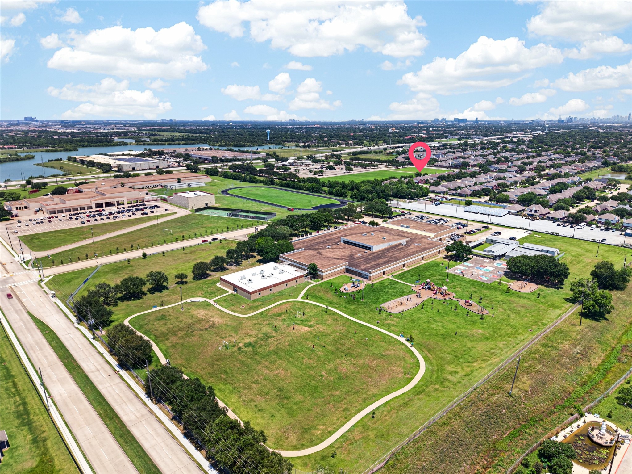 This expansive aerial view highlights the home's incredible location, situated within walking distance of local schools, extensive playgrounds, and sprawling green spaces.